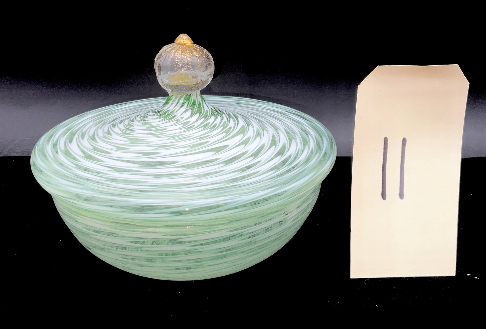 Murano Style Mezza Filigrana Lidded Art Glass Candy Dish: This elegant hand-blown lidded bowl features a mezza filigrana technique with seafoam green and opaque white spiral ribbons. The domed lid is topped with a clear globular finial containing suspended g
