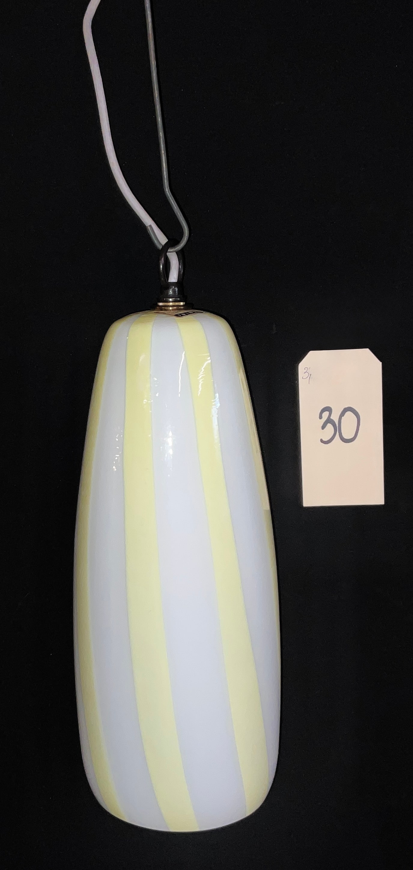 Massimo Vignelli for Venini Murano Glass Pendant Lamp, 1950s: This mid-century modern pendant lamp was designed by Massimo Vignelli for Venini and features an elongated ovoid shade crafted from Murano glass. The design showcases alternating vertical stripes of o
