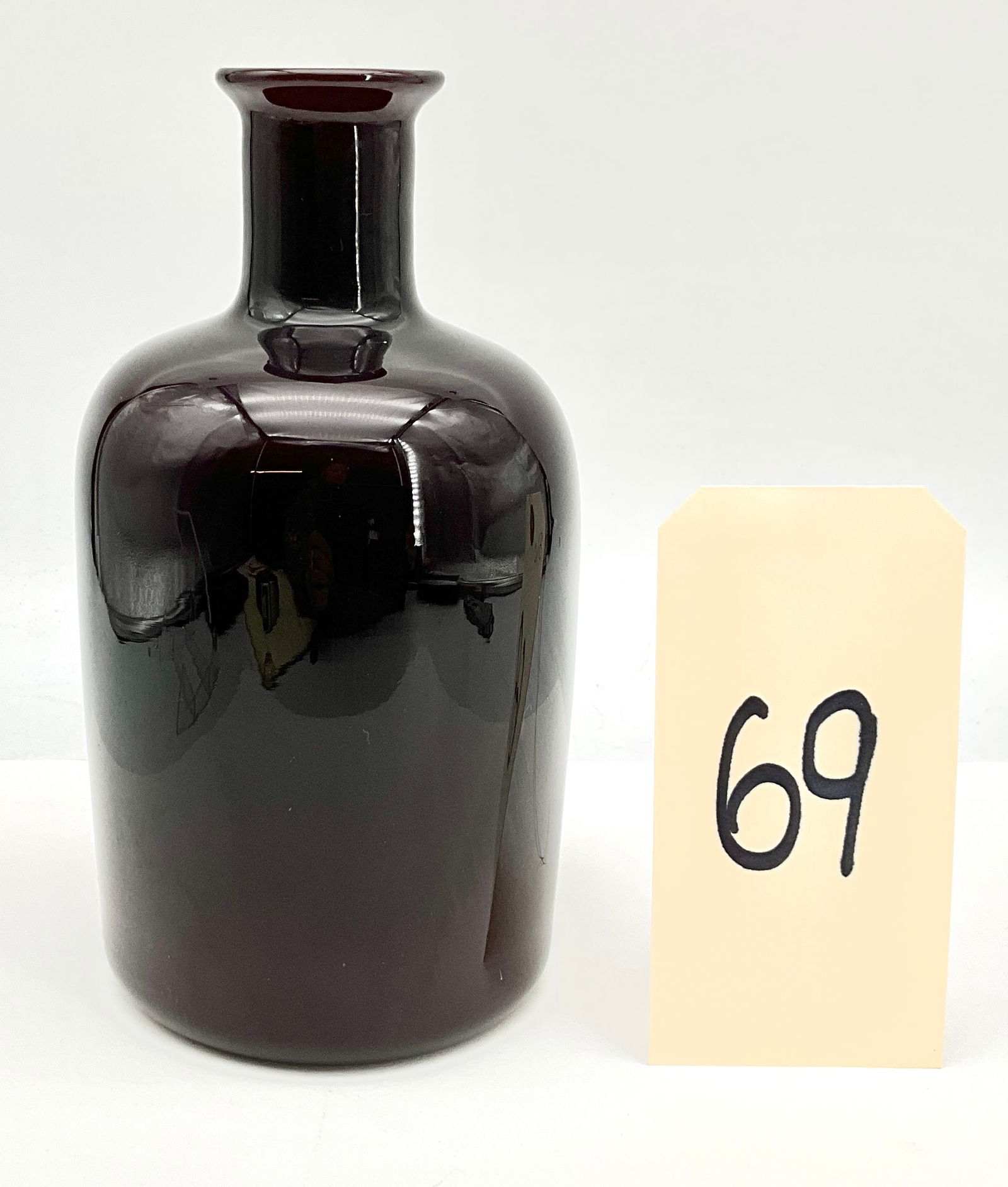 Italian Art Glass Vase: This Italian art glass vase is hand-blown using the incamiciato technique, featuring a deep amethyst exterior cased over an opaque white interior. The minimalist cylindrical form is finished with roun