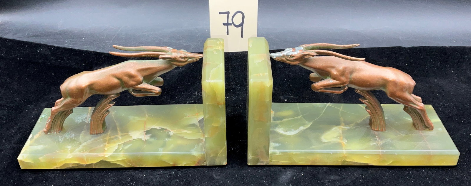 Pair of Art Deco Style Patinated Metal Leaping Gazelle Bookends on Green Onyx Bases: A pair of Art Deco style bookends featuring stylized leaping gazelles cast in metal with a copper-tone patinated finish. The figures are mounted on polished L-shaped green onyx bases characterized by