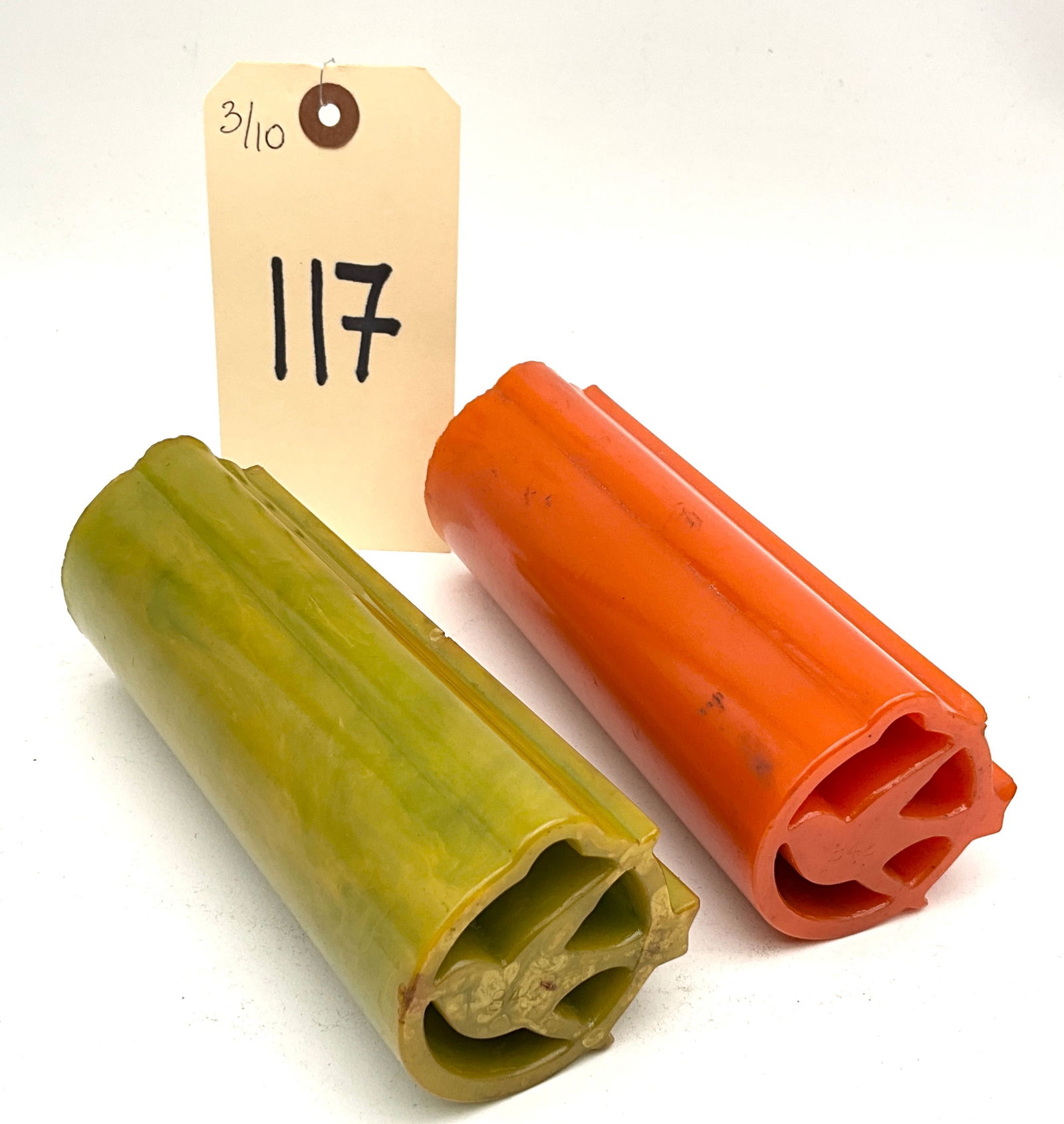 Vintage Uncut Bakelite and Catalin Jewelry Rods: This pair of vintage uncut Bakelite or Catalin rods represents rare new old stock material from the Art Deco period, circa 1930-1940. The collection includes one olive green and one orange-red rod, bo