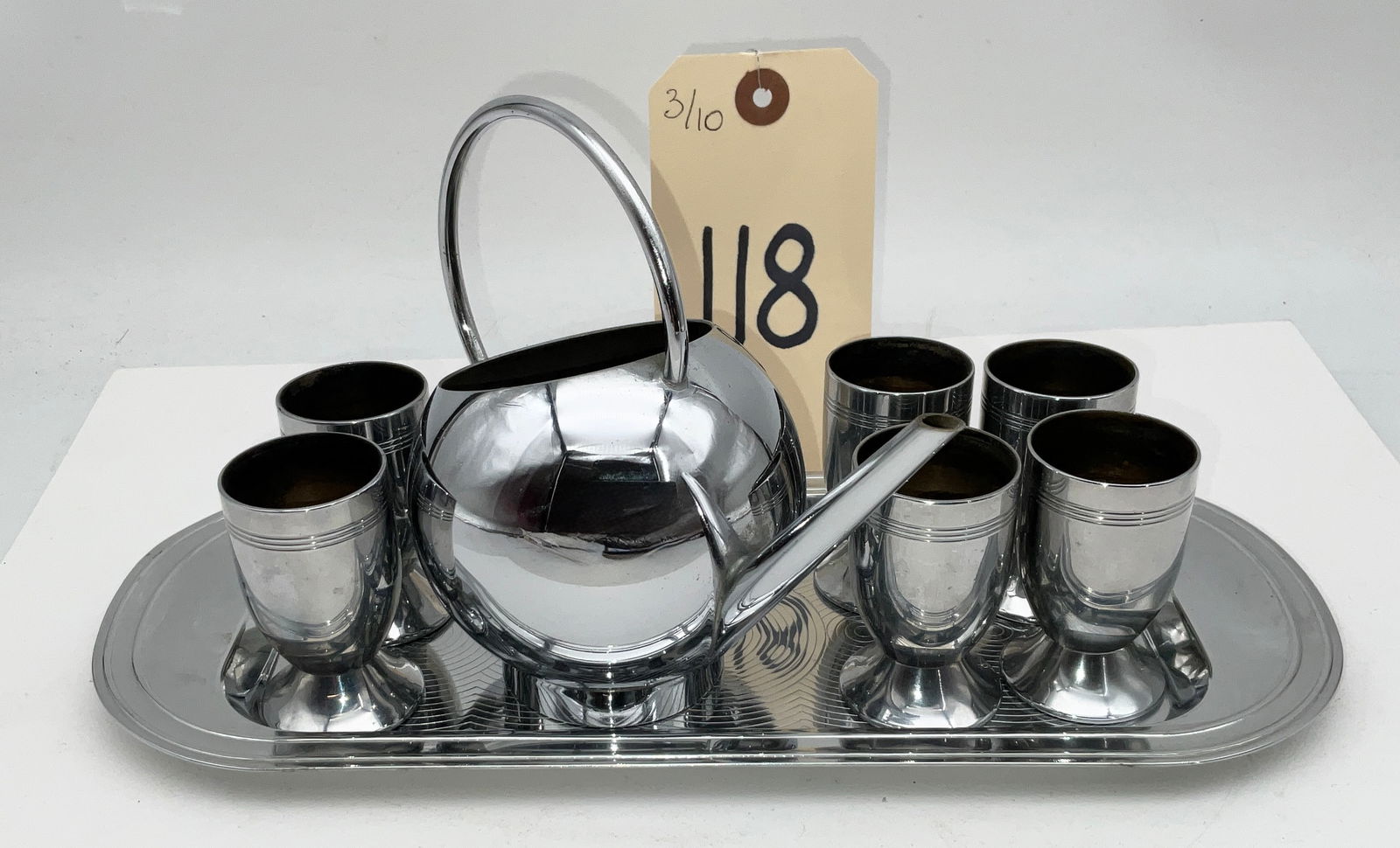 Chase USA Art Deco Chrome Spherical Pitcher and Cup Set with Tray: This sleek Art Deco beverage service was manufactured by Chase Brass and Copper Company in the United States during the 1930s. The set features a modernist spherical pitcher with a high-arched handle