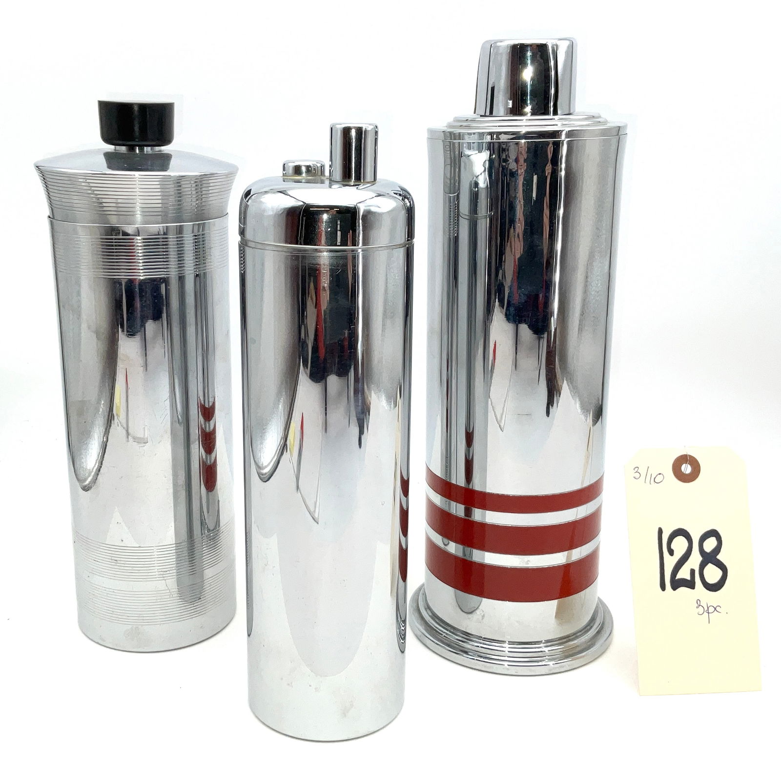 Three Art Deco Chrome-Plated Cocktail Shakers by Chase, Revere, and Manning-Bowman, As-is.: This collection of three Art Deco period cocktail shakers (c. 1920-1940) features chrome-plated construction with iconic machine-age styling. The group includes a Chase Gaiety shaker with machine-inci