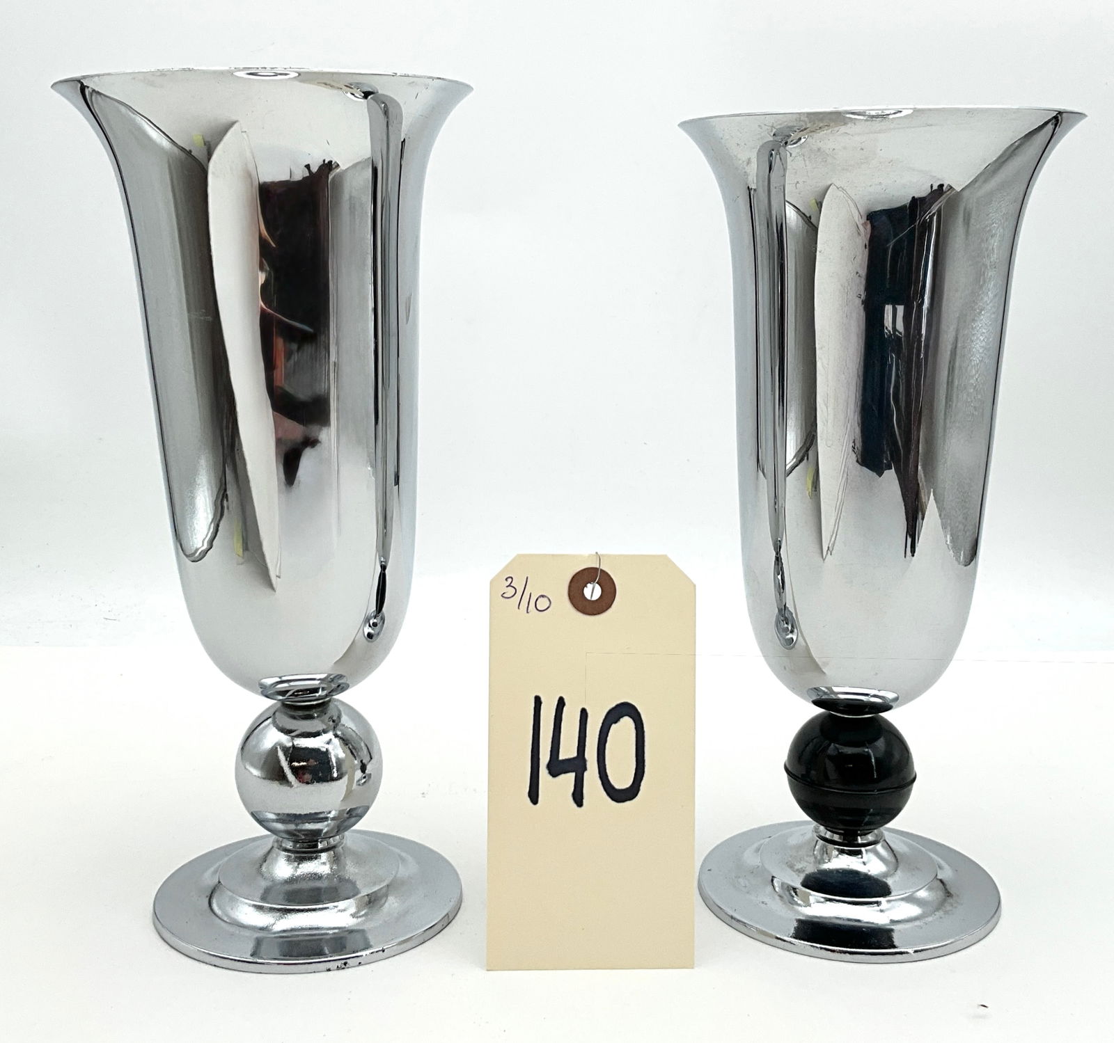 Bruce Fox Inc. Mid-Century Modern Chrome Trumpet Vases: This pair of mid-century modern trumpet vases by Bruce Fox Inc. features polished chrome-plated exteriors over cast metal interiors and bases. The flared vessels are set on circular pedestal bases, wi