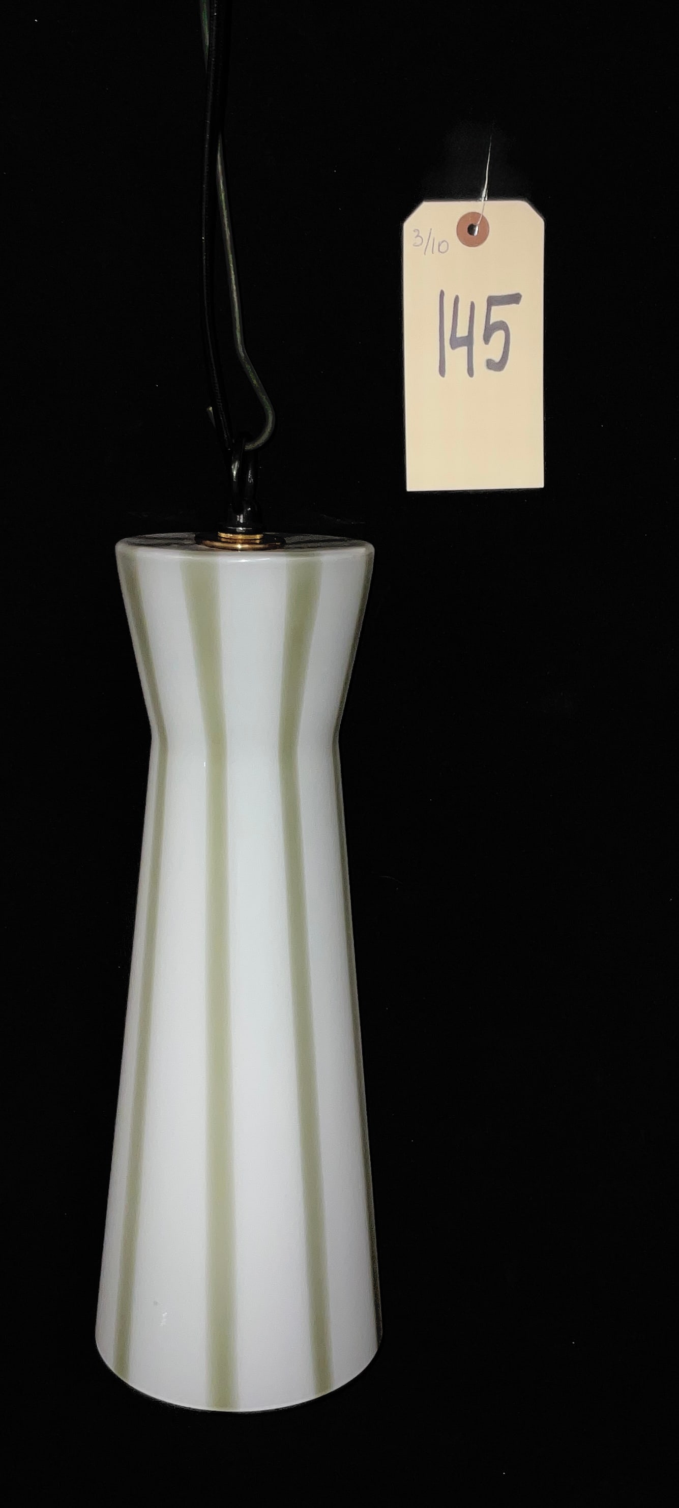 Venini Murano Mid-Century Striped Glass Pendant Light: This mid-century modern pendant light is manufactured by Venini Murano and features an elongated, tapered glass shade. The construction consists of opaque white glass accented by vertical pale green s
