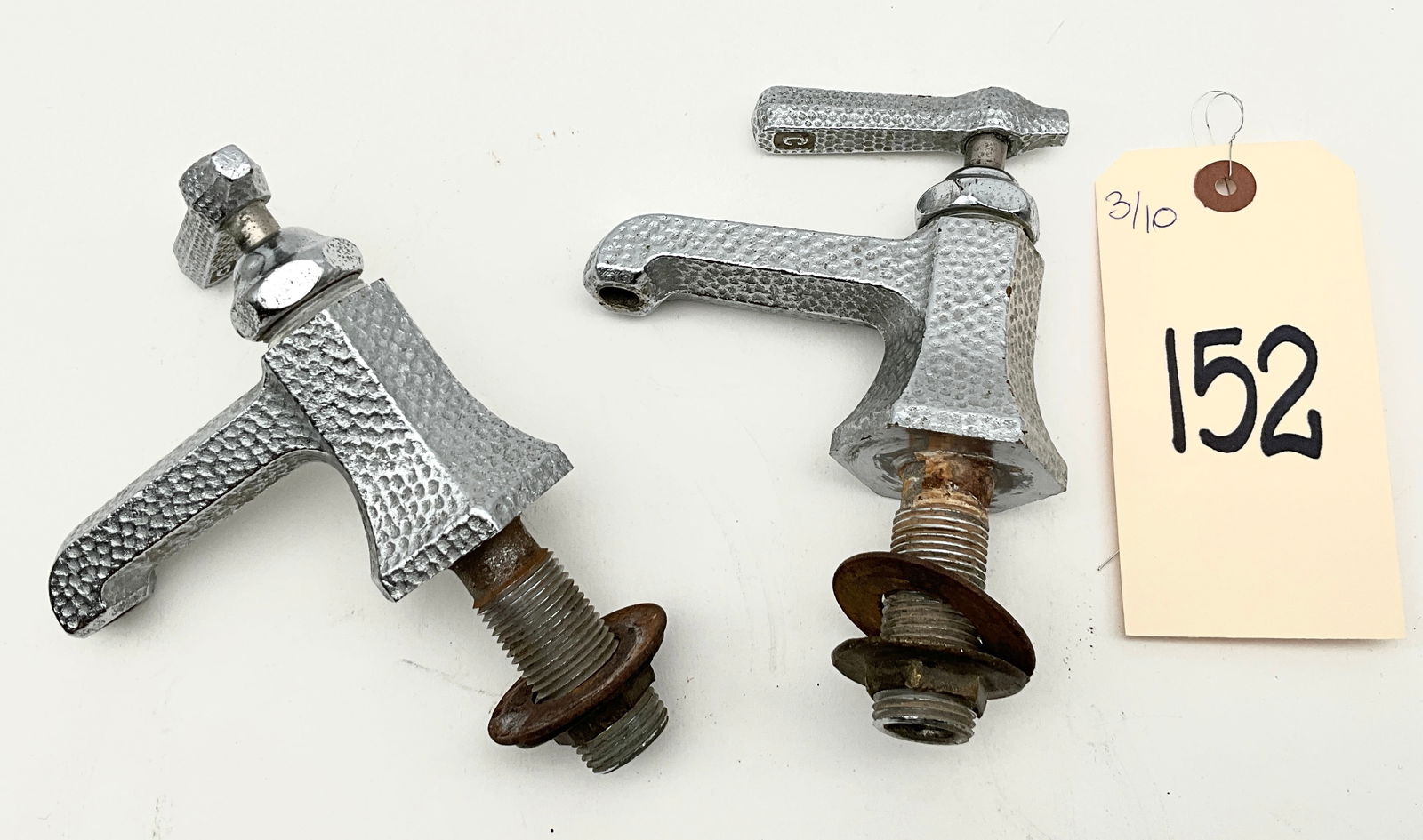 Pair of Vintage Hammered Chrome Bathroom Faucets, Mid-Century Art Deco Style: This pair of vintage bathroom faucets features a distinctive hammered chrome-plated finish over metal, showcasing a blend of Mid-Century and Art Deco design. Each unit is constructed with a tapered he