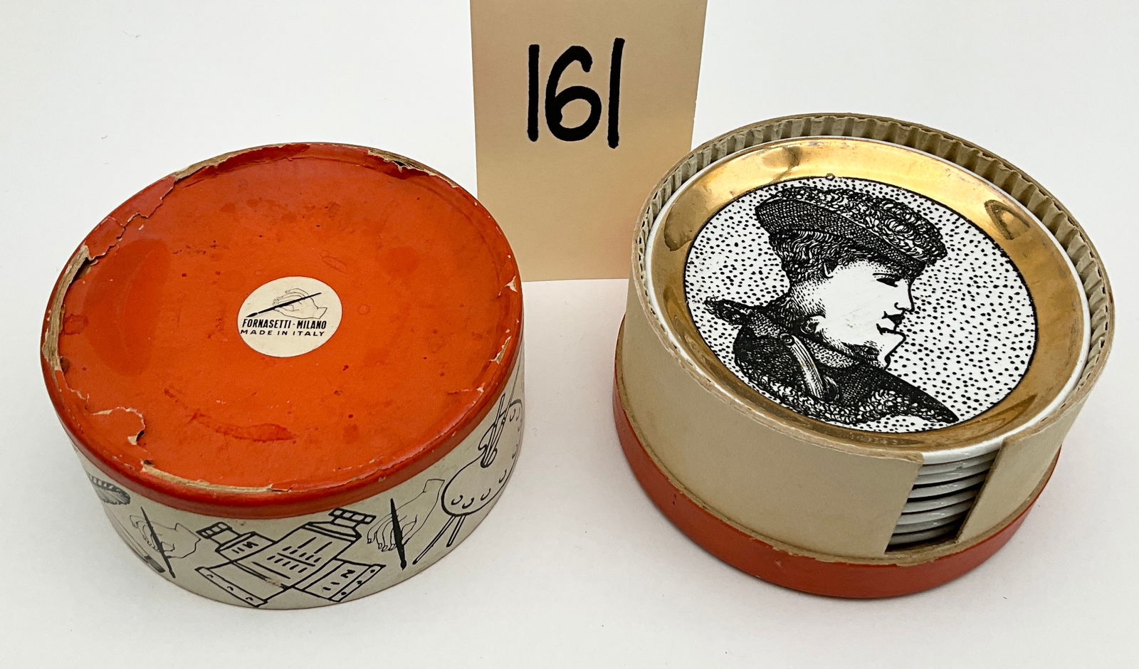 Piero Fornasetti and Bucciarelli, Gilded Ceramic, Coasters: This set of eight vintage Italian ceramic coasters includes six pieces by Piero Fornasetti and two by Bucciarelli. The Fornasetti coasters feature black transfer-printed classical chariot motifs on po