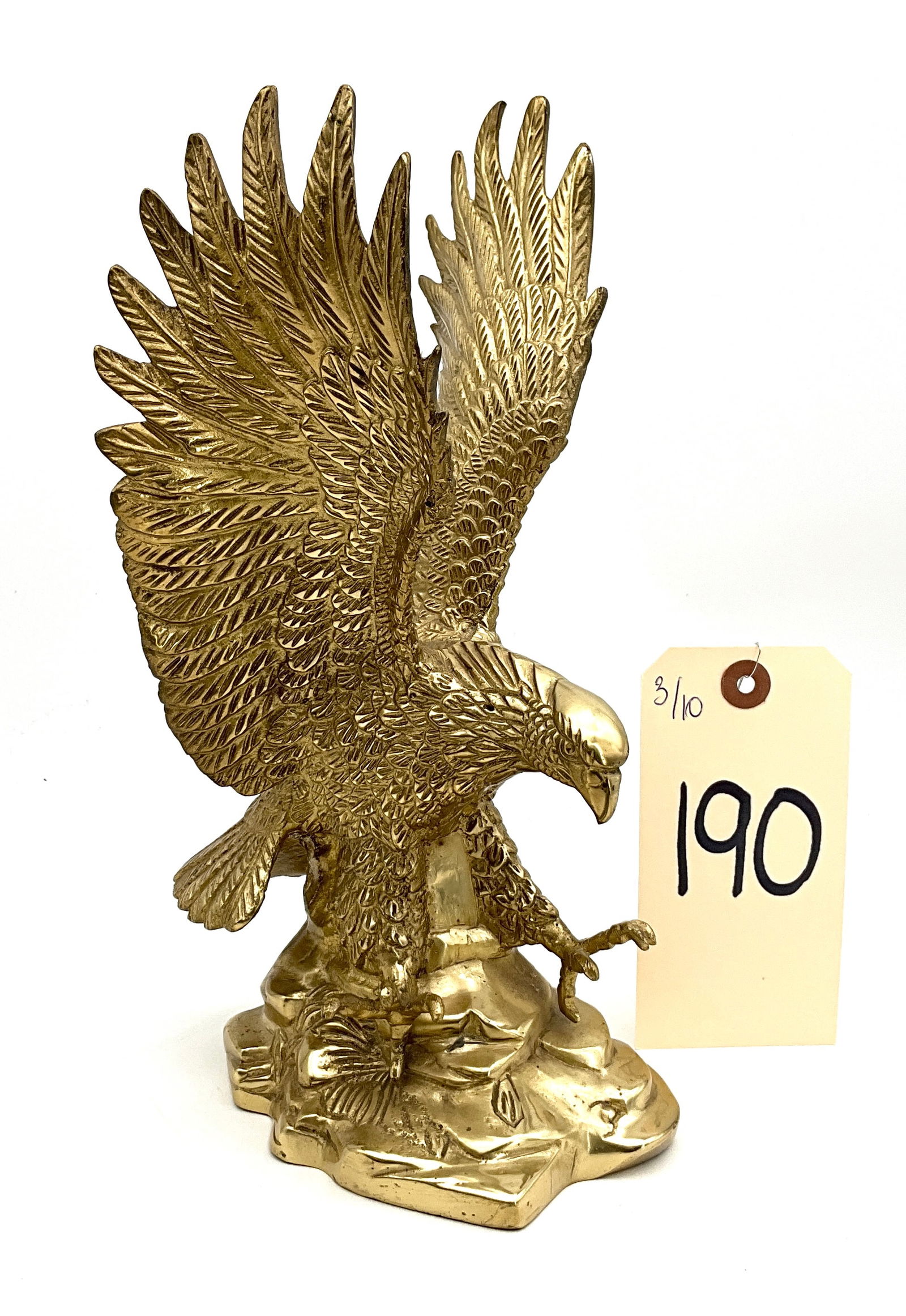 Gatco Style Solid Brass American Eagle Statue: This cast brass sculpture depicts an American bald eagle in a dynamic landing pose with wings fully unfurled and talons outstretched. The piece is constructed from solid brass with a polished finish a