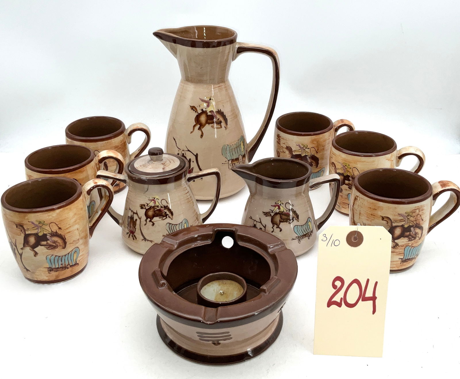 Mid-Century Giftcraft Japan Western Cowboy Ceramic Tableware Set: This mid-century ceramic tableware collection, imported by Giftcraft Japan, features a hand-painted Western cowboy motif. The set includes a large pitcher, a lidded sugar bowl, a creamer, six mugs, an