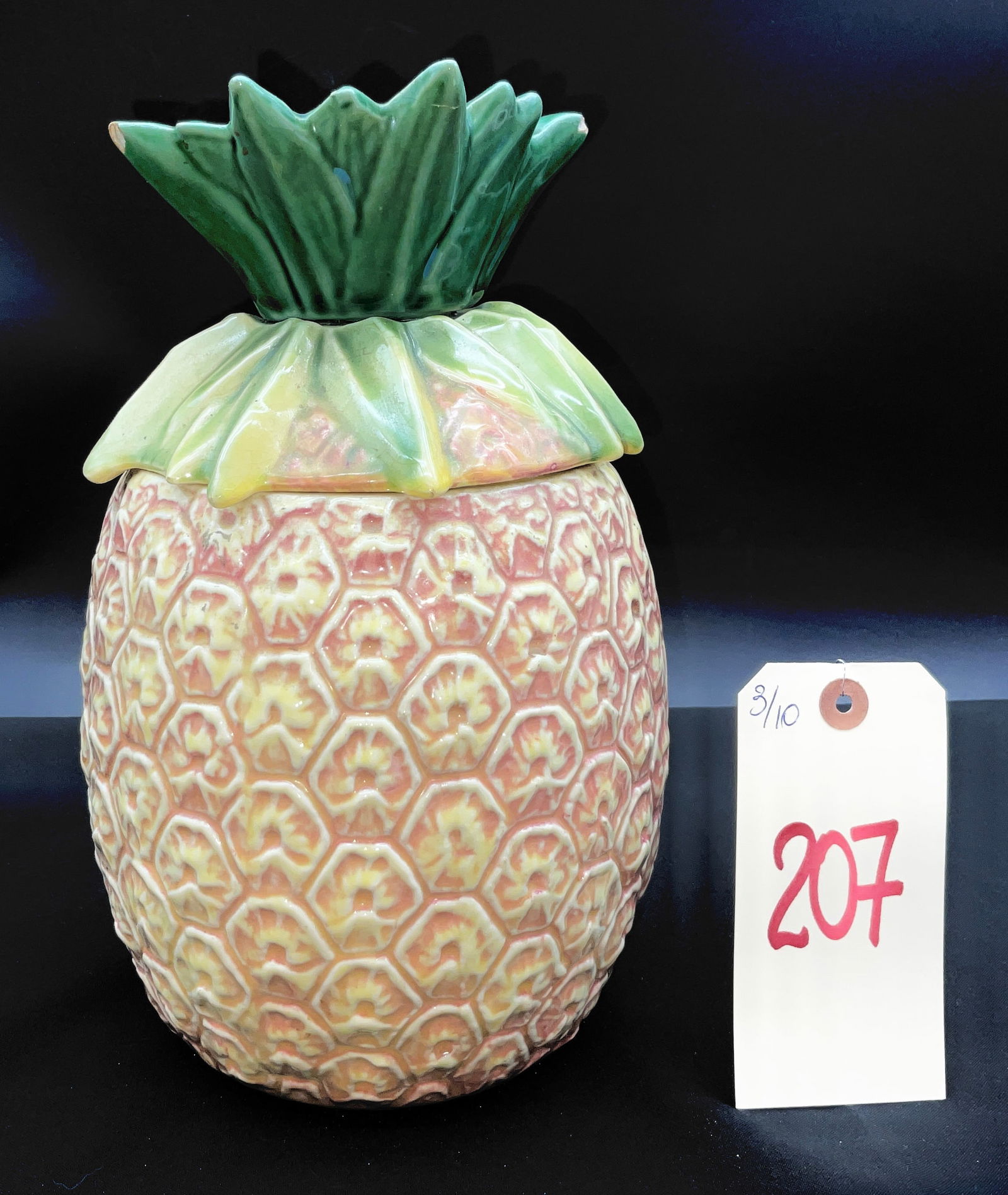 McCoy Pineapple Cookie Jar: This vintage McCoy glazed earthenware cookie jar is modeled in the form of a tropical pineapple. The piece features molded relief decoration with hand-applied polychrome glazes in shades of pink, yell