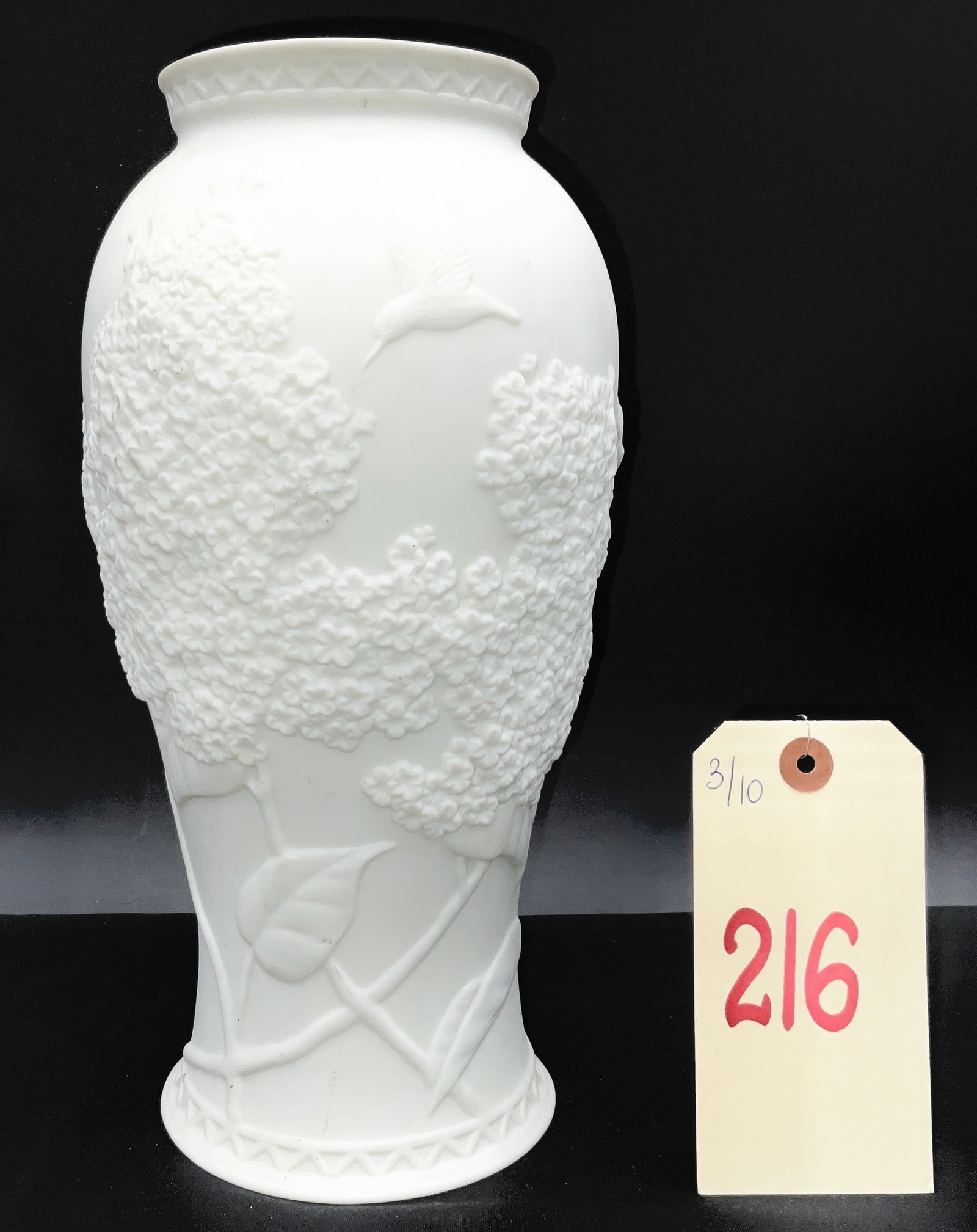 Cheryl Johnson for Goebel, 'Hummingbirds', Bas-Relief Bisque Porcelain with Transfer-Printed Mark: Designed by Cheryl Johnson for Goebel, this white bisque porcelain vase features an elaborate bas-relief depicting hummingbirds in flight among dense floral clusters. The matte, unglazed surface highl