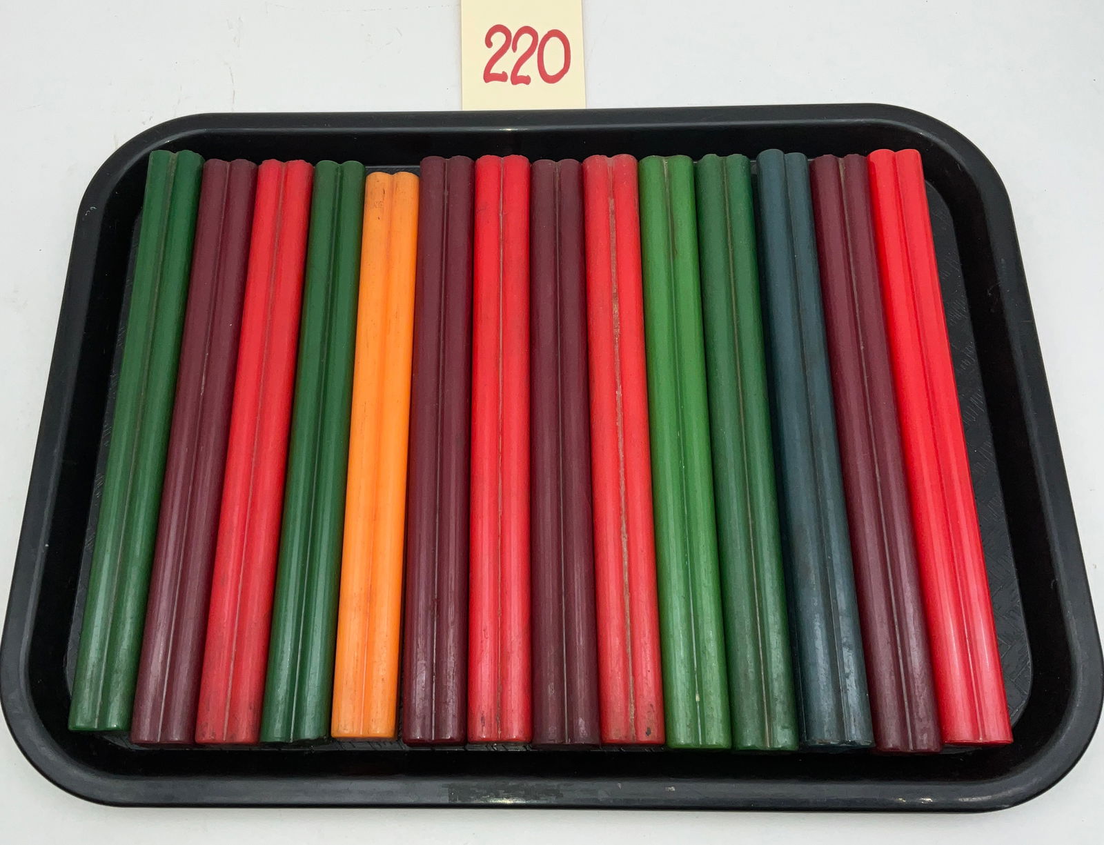 Vintage Bakelite Uncut Jewelry Rods, Multi-Color Collection: This assortment features multiple uncut Bakelite rods in a vibrant array of colors including red, green, orange, and teal. These vintage rods possess a distinctive double-barrel profile and were origi