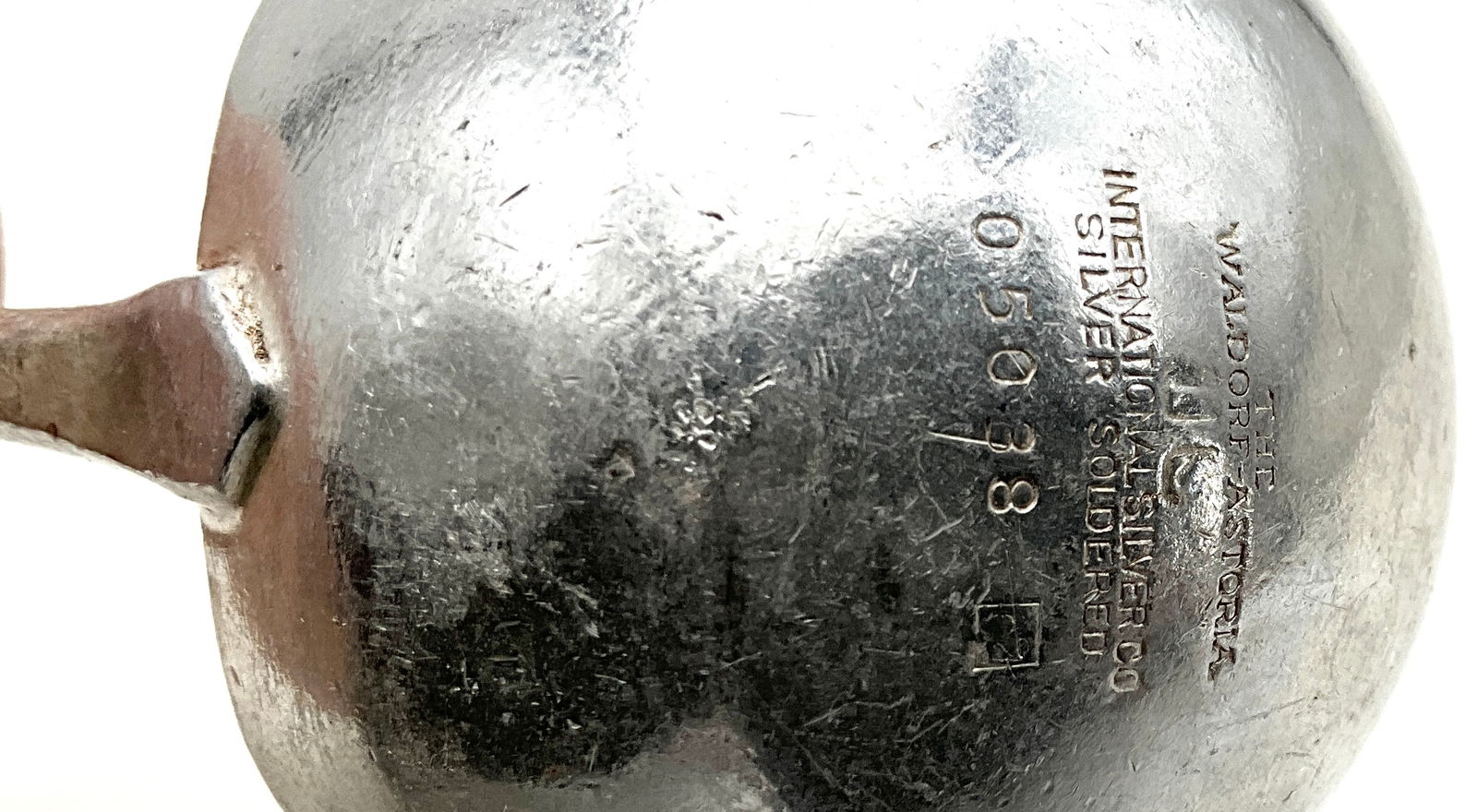 International Silver Co. Waldorf-Astoria Silver-Soldered Straining Punch Ladle: This silver-soldered hotel ware punch ladle was manufactured by the International Silver Co. specifically for the Waldorf-Astoria. The design features a deep oval bowl with an integrated perforated st