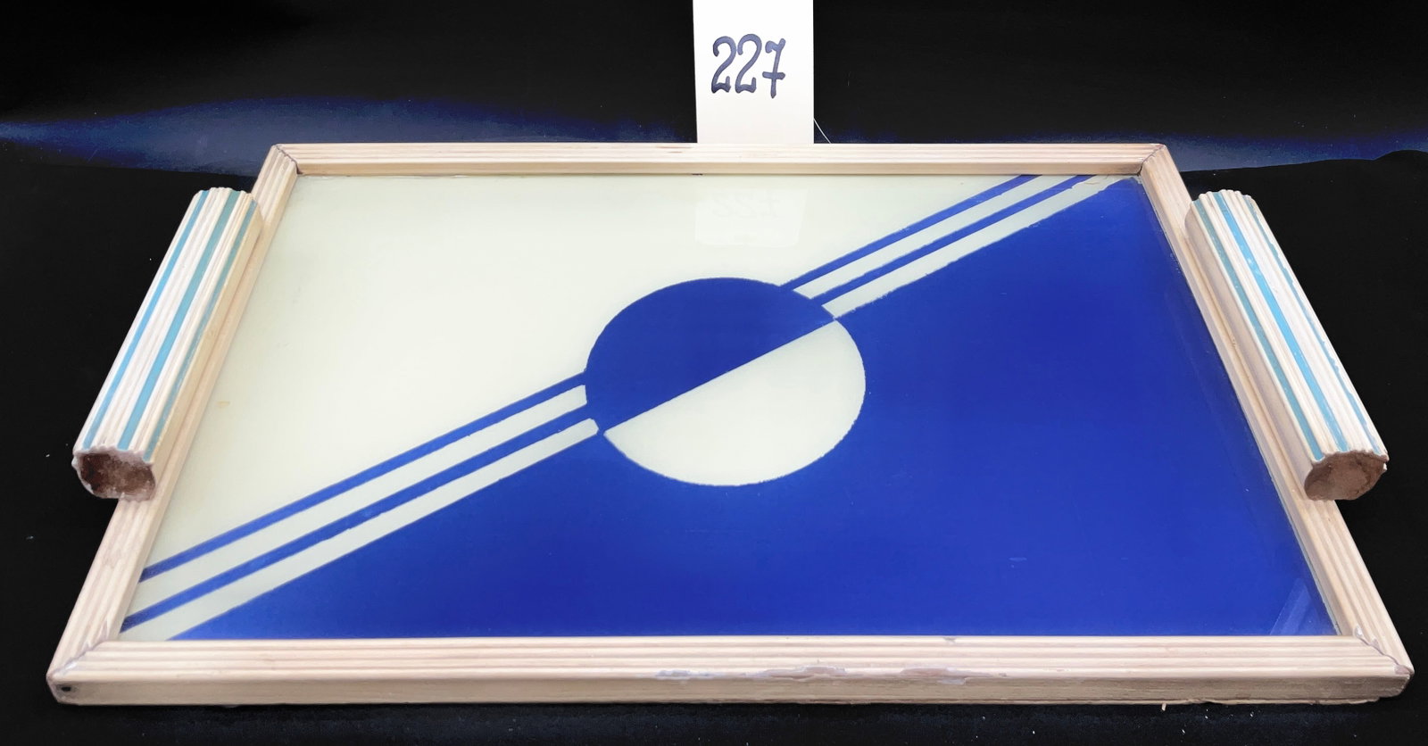 Art Deco Style Painted Wood and Reverse Painted Glass Geometric Tray: This Art Deco style rectangular tray features a striking blue and white geometric graphic under glass, characterized by a bisected central circle and diagonal speed lines. The piece is constructed wit