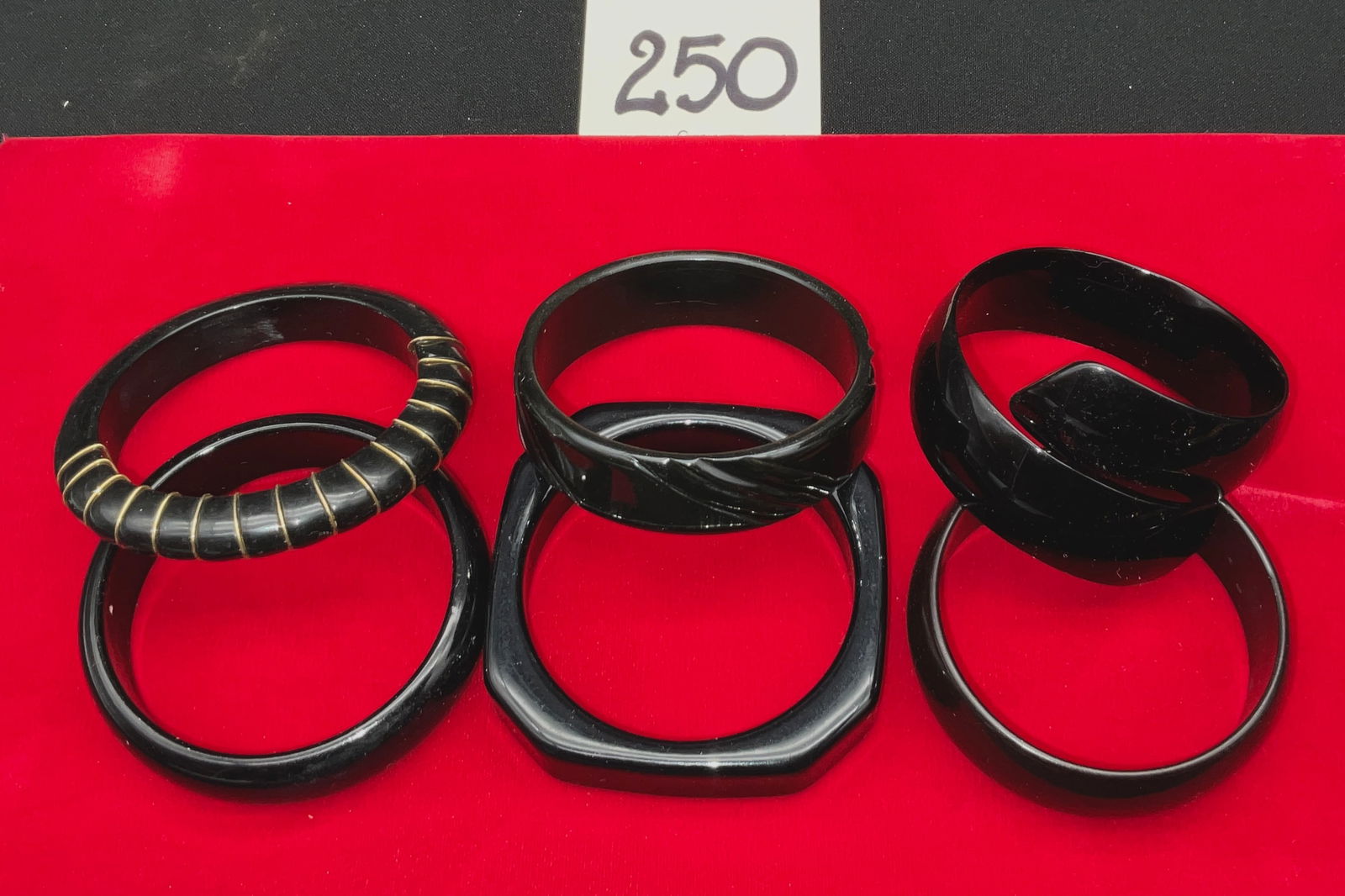 Unmarked, Vintage Bangle Collection, Black Bakelite Jewelry, 1920s-1930s: This collection features unmarked generic models of vintage black Bakelite bangles with no serial numbers. The construction utilizes early synthetic resins and gold-tone wire with diameters of 2.75"