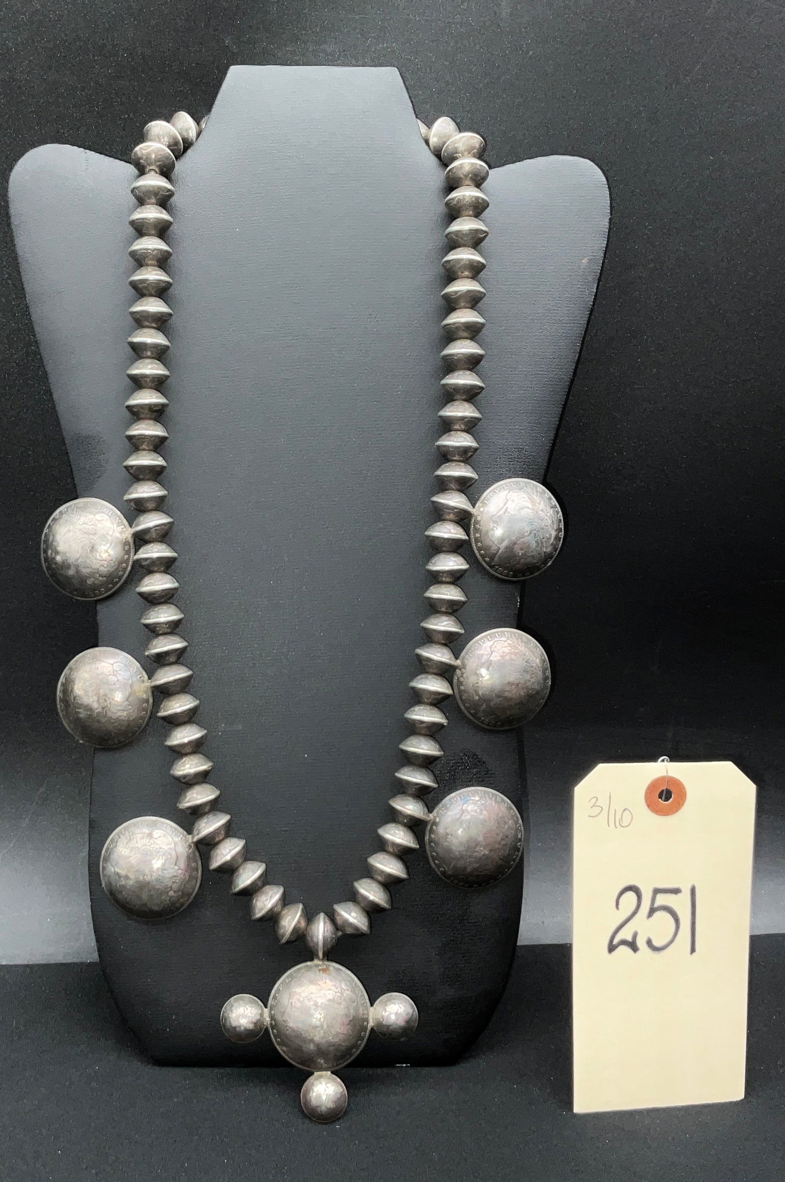 Silver Navajo Pearl Necklace with Morgan Silver Dollar Pendants: This handmade sterling silver Navajo Pearl necklace is composed of approximately 56 bench-made bi-conical beads fashioned from United States Mercury dimes. The design features six domed Morgan silver