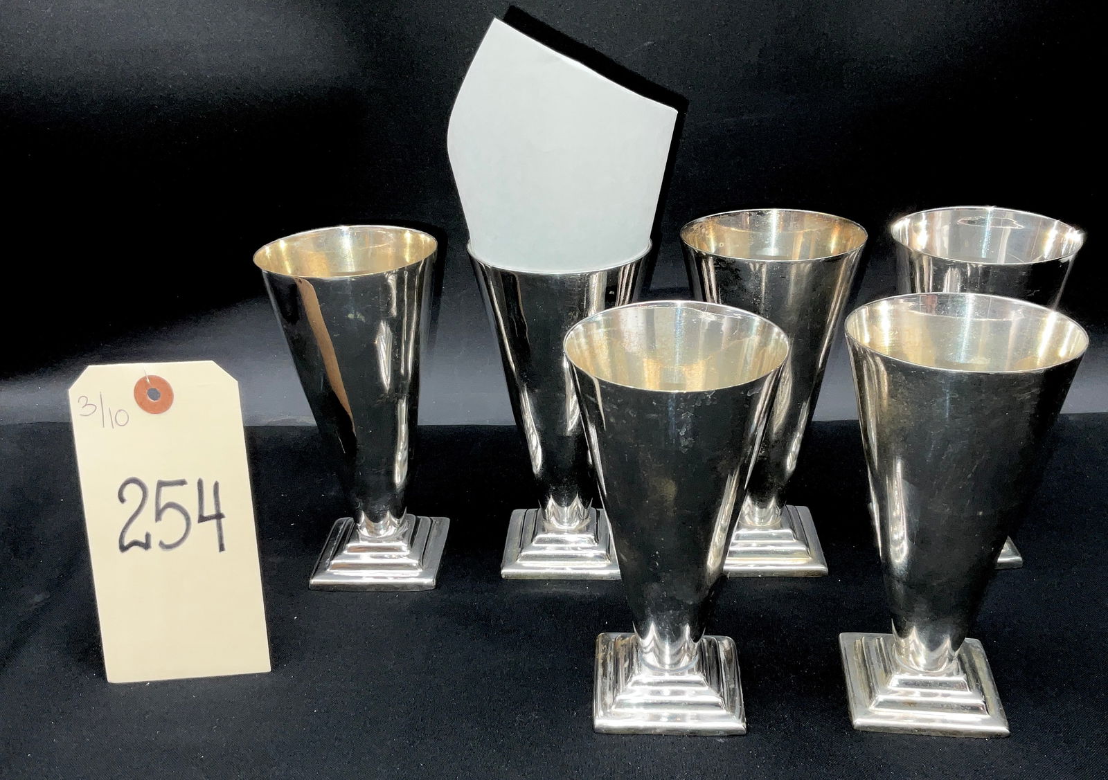 Set of Six Modernist Silver Plate Conical Toasting Cups: This set of six silver-plated toasting cups features a striking Art Deco-inspired modernist design with tapered conical bodies from the Waldorf-Astoria. Each vessel is supported by a distinctive