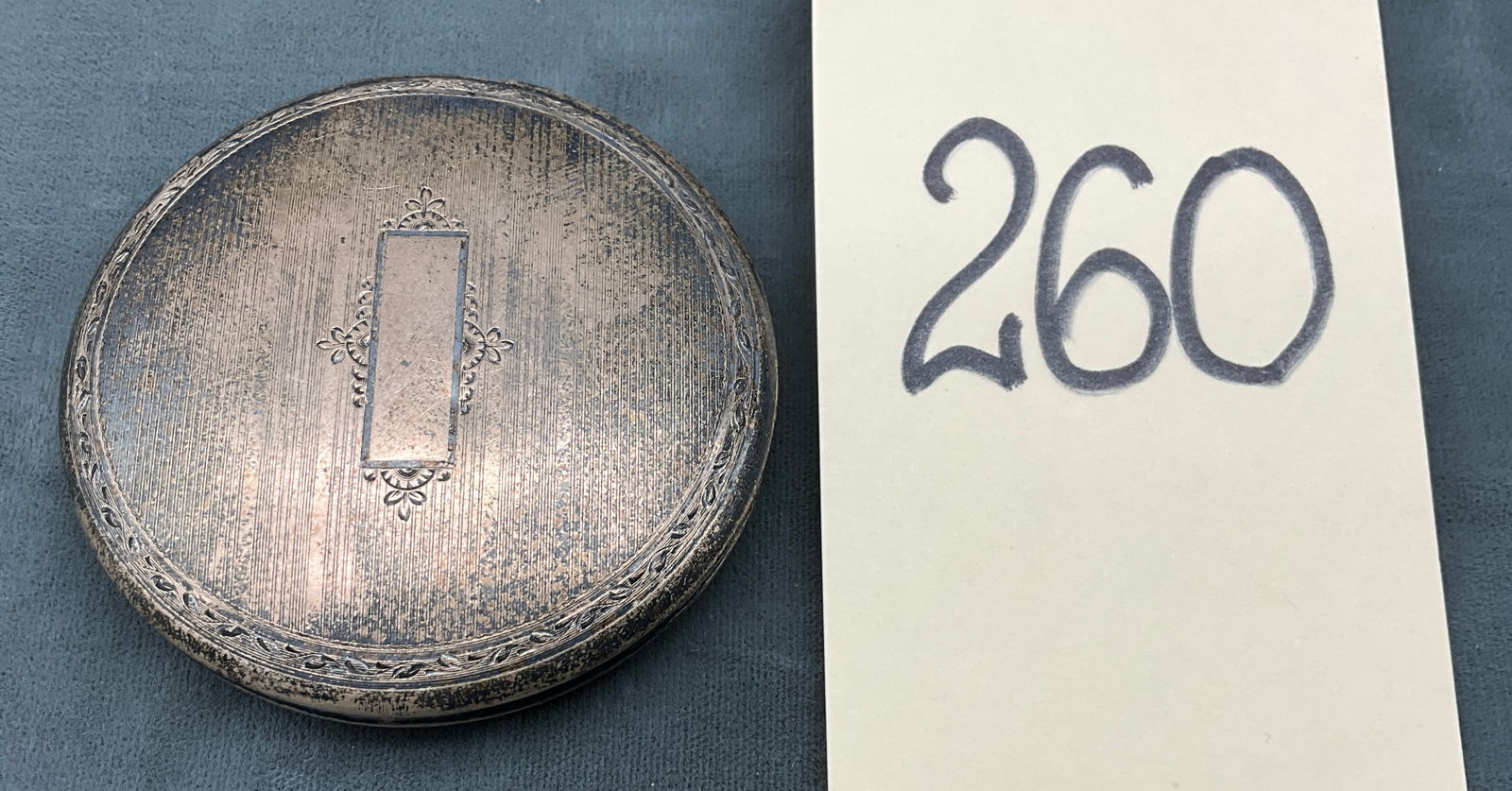 Sterling Silver, Circular Compact, Engine-Turned Design: This antique sterling silver circular compact by Wightman & Hough Co. features a classic engine-turned pinstripe pattern with a central unengraved cartouche and no gemstones. The interior is