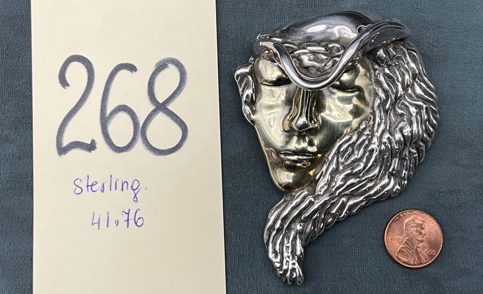 Vintage Art Nouveau Style Sterling Silver High Relief Lady with Hat Brooch Pendant: This substantial sterling silver piece functions as both a brooch and a pendant, featuring a high-relief modernist depiction of a woman with flowing hair and a wide-brimmed hat. The facial features ar