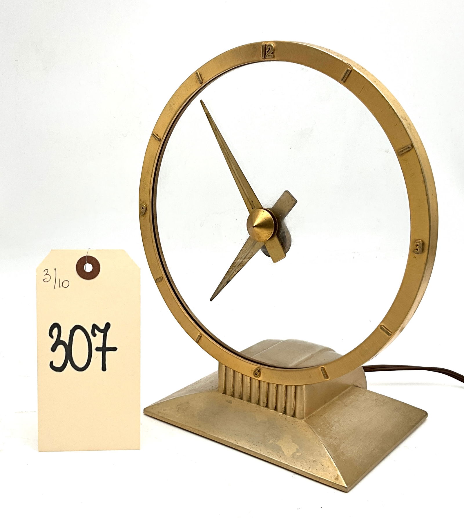Jefferson Golden Hour Electric Clock, Mid-Century Modern, Gold-Tone Finish: This Mid-Century Modern Jefferson Golden Hour electric clock, was manufactured by the Jefferson Electric Company of Bellwood, Illinois. The timepiece features a circular gold-toned metal frame with ra