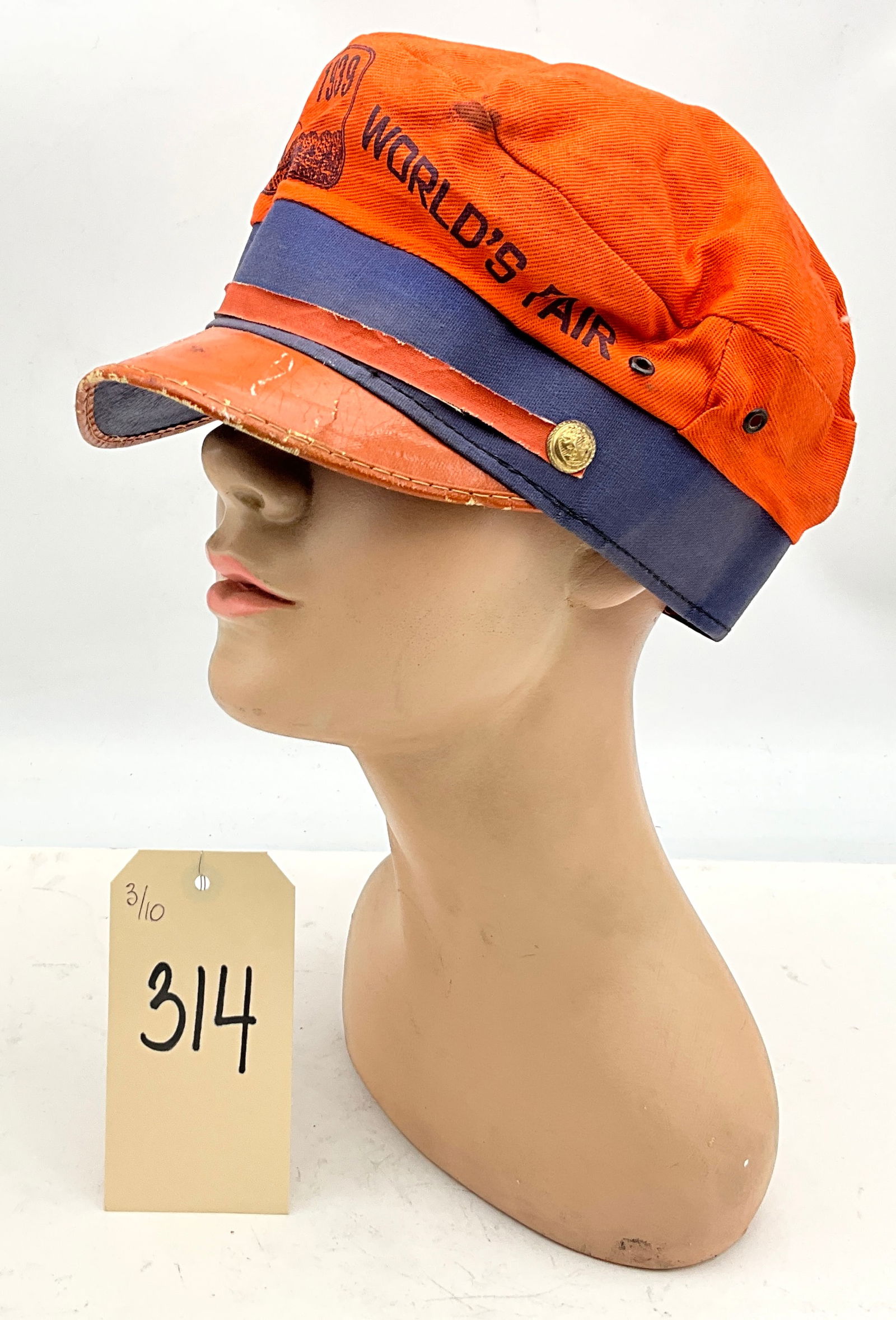 1939 New York World's Fair Souvenir Orange and Navy Cadet Cap: This 1939 New York World's Fair souvenir cadet style cap is constructed from orange and navy blue cotton canvas. The crown features printed text reading NEW YORK WORLD'S FAIR and 1939 alongside a