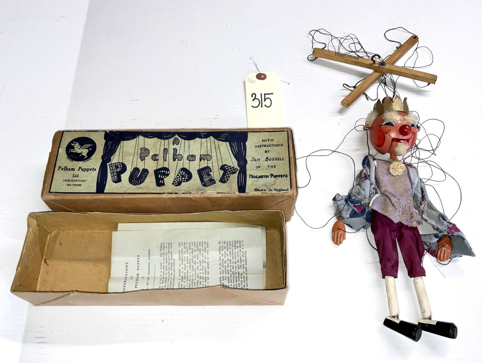 Pelham Puppets Ltd. Type SM King Marionette with Original Box, circa 1950s: This 14" Pelham puppet represents a royal figure from the SM range, featuring a hand-painted wooden head with an articulated jaw and a gold-toned crown. The marionette is dressed in a