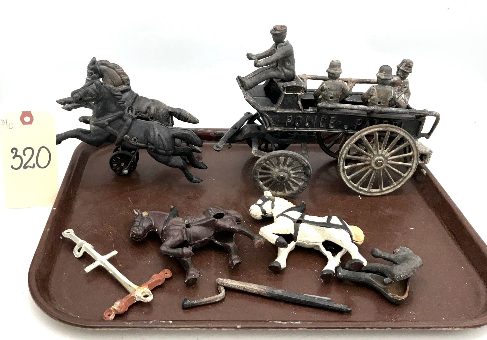 Hubley Police Patrol Horse Drawn Wagon, Early 20th Century: This antique Hubley horse-drawn police patrol wagon is a classic cast iron pull toy measuring 18 inches long and 8.5 inches high. The set features a two-horse galloping team pulling a wagon with