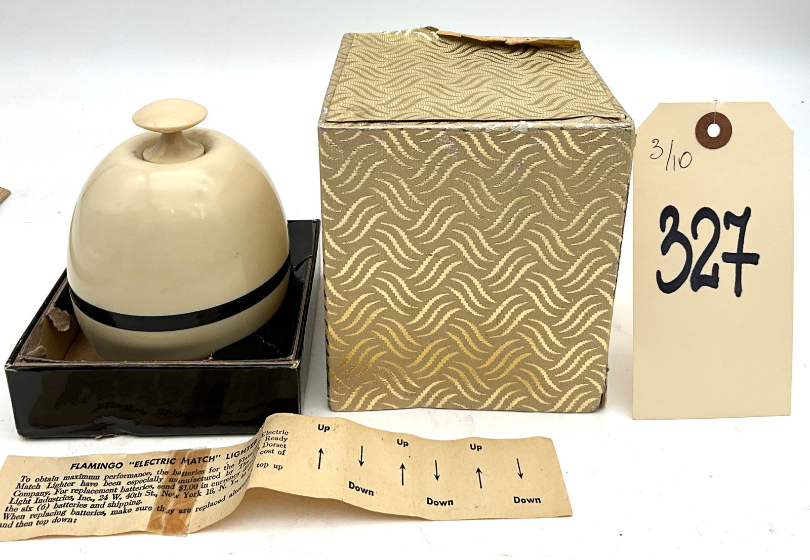 Flamingo Electric Match Table Lighter with Original Box, circa 1955: This mid-century Flamingo Electric Match table lighter was manufactured by Dorset Light Industries, Inc. of New York and features a spherical cream plastic body with a black accent band. The unit