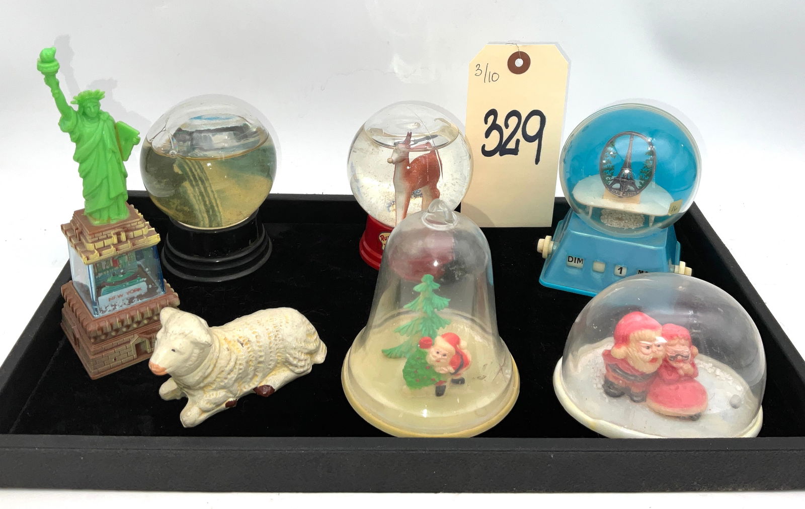 The Driss Co. and Hong Kong, Vintage Holiday and Travel Snow Globe Collection: This collection features seven vintage souvenir items, including a Rudolph the Red-Nosed Reindeer snow globe by The Driss Co. and an Eiffel Tower perpetual calendar globe. The lot also contains