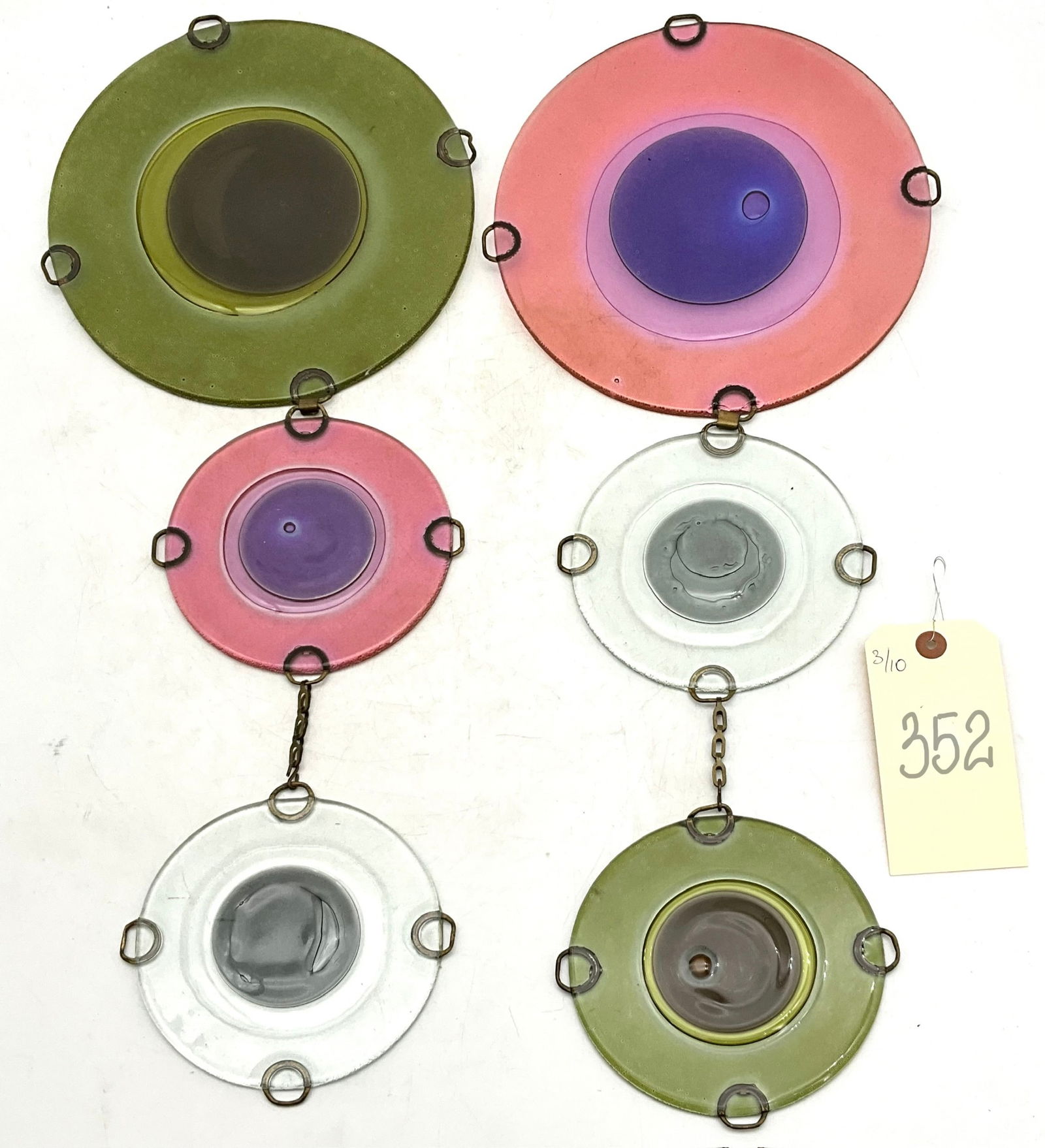 Set of kiln-formed fused glass Rondelays: This set of kiln-formed fused glass Rondelays is attributed to Michael and Frances Higgins and dates to the mid-century modern era. The composition features six circular discs in a palette of avocado