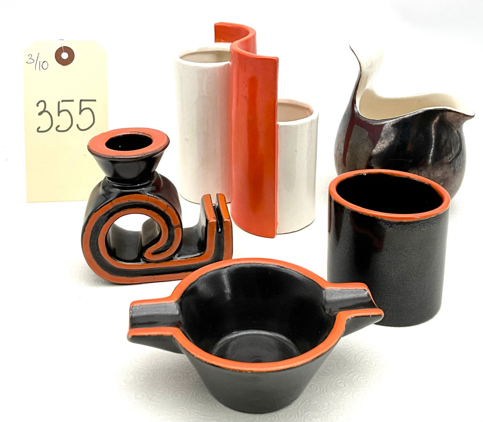 Collection of Mid-Century Modern Ceramic Vessels and Sculptural Objects: This five-piece collection features stylized mid-century modern forms including a snail-form candle holder and ashtray attributed to Roth Keramik of West Germany. The set is characterized by a bold bl