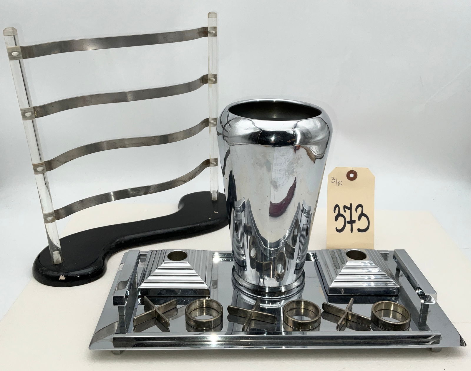 Revere Copper and Brass, Inc. Art Deco Chrome Desk Set and Modernist Stand: This Art Deco chrome-plated desk or smoking set by Revere Copper and Brass, Inc. features a 7"x14" tray with tiered geometric handles and a central tapered vessel. The set includes two pyramid-form ho