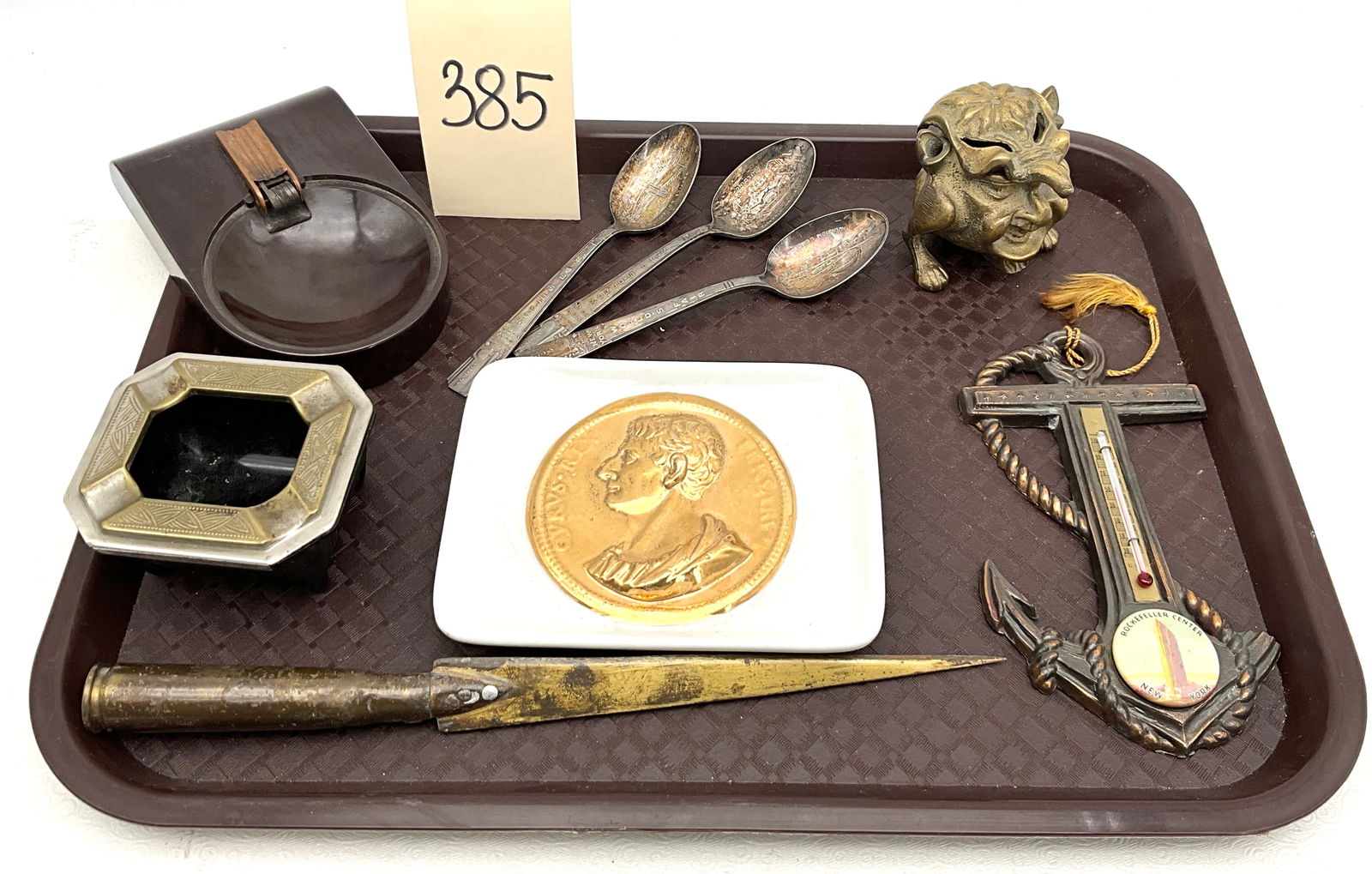 Fornasetti Milano Ceramic Tray, Chase Brass Ashtray, and Vintage New York Souvenir Collection, circa: This curated lot includes a Fornasetti Milano ceramic tray featuring a gold-toned profile medallion and a Chase brass Slide Top ashtray with a black glass insert. The collection is highlighted by 1939