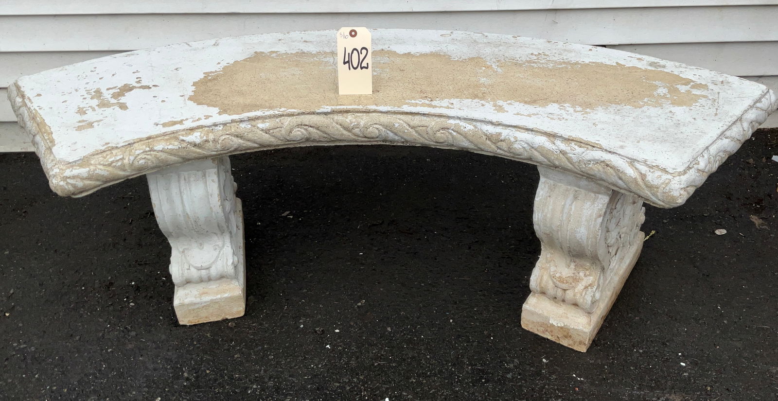 Cast Stone Curved Garden Bench Attributed to Kenneth Lynch and Sons: This classical curved garden bench is crafted from cast stone and features ornate scroll-carved volute supports. The seat is finished with a decorative rope-twist and scrolled edge, a design character