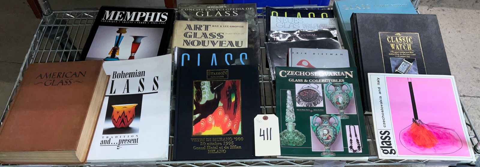 A Collection of Books and Catalogs on Art Glass and Horology. Multiple Publishers, 1941-1997. (DJ): This collection comprises approximately fifteen volumes focusing on the history and artistry of glass, alongside a significant work on horology. Key titles include Memphis: Ceramique - Argent - Verre