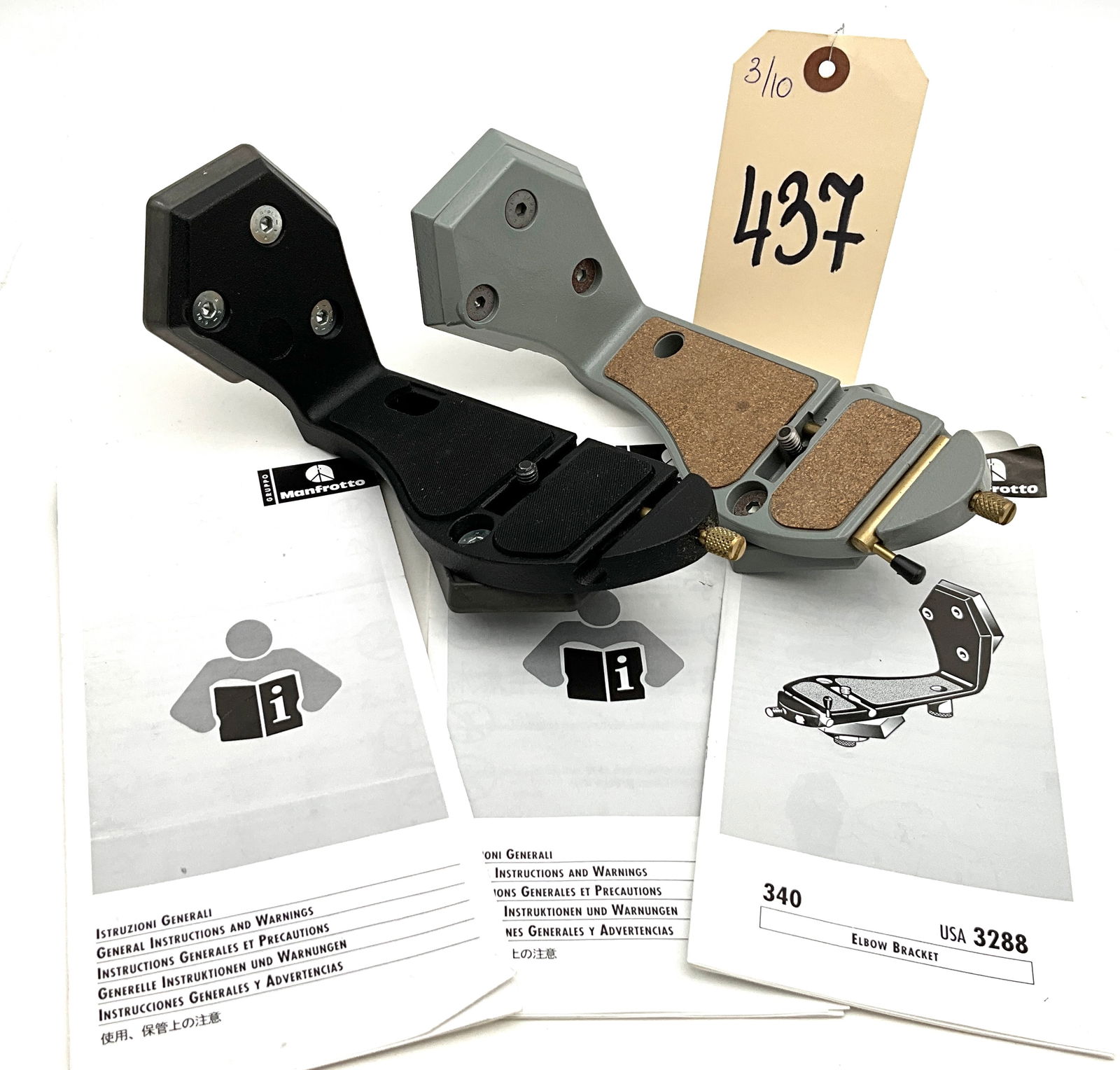 A Pair of Manfrotto 340 USA 3288 Professional Elbow Brackets: This lot features two Manfrotto 340 (USA 3288) professional elbow brackets constructed from durable cast metal. One bracket is finished in matte black with rubberized mounting pads, while the second d