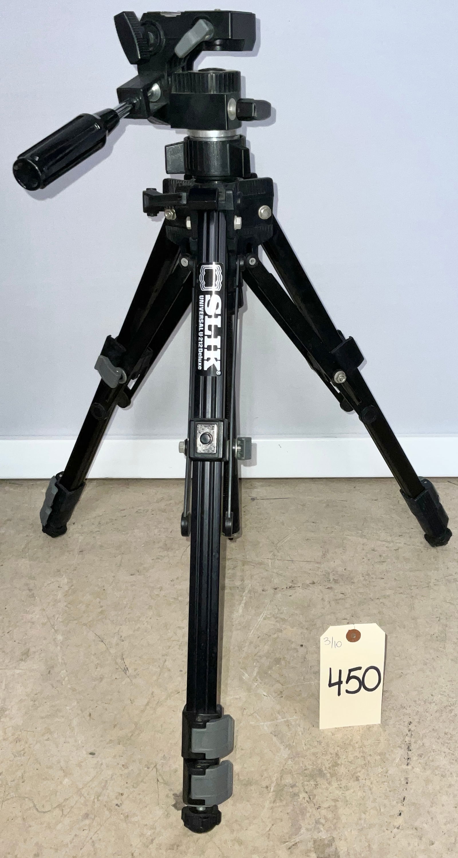 SLIK Universal U-212 Deluxe Camera Tripod with 3-Way Pan-and-Tilt Head, Late 20th Century: This SLIK Universal U-212 Deluxe tripod features a robust design with black-finished metal leg sections and a geared center column. It is equipped with a SLIK 3873 three-way pan-and-tilt head, a singl
