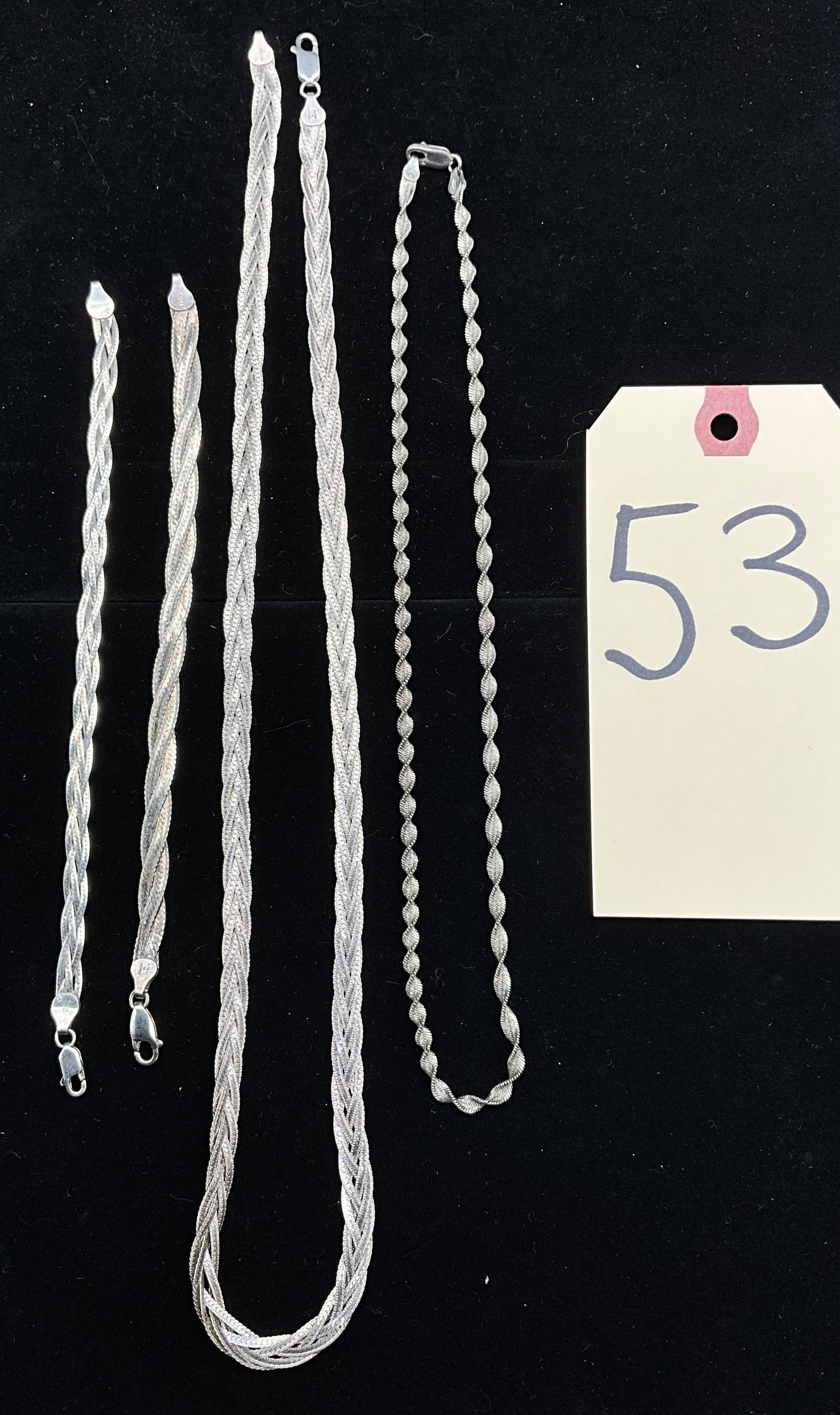 A Collection of Italian Sterling Silver Braided and Twisted Chains: This collection of Italian sterling silver jewelry features an assortment of braided multi-strand and twisted ribbon chain designs. Each piece is secured with a functional lobster claw clasp and bears