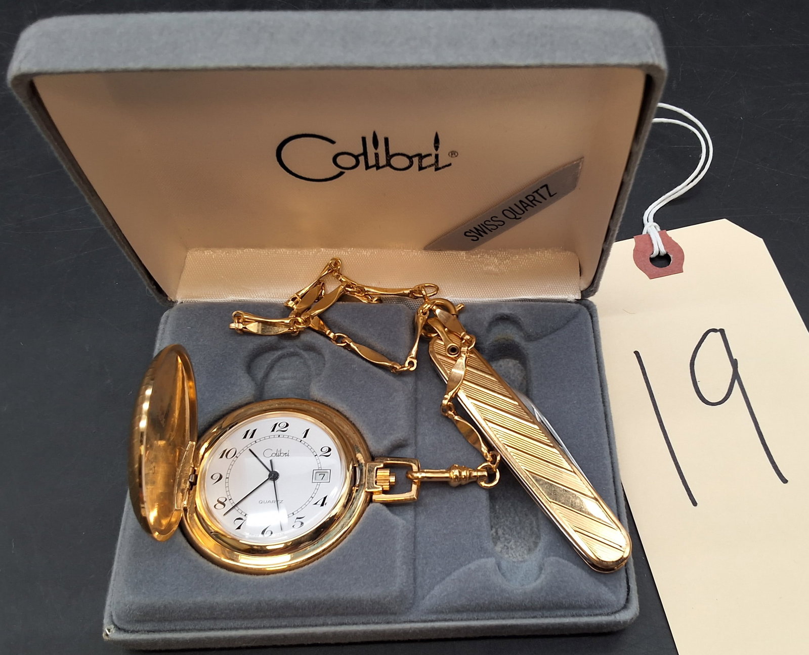 Colibri gold tone pocket watch with knife: Colibri gold tone pocket watch with knife Condition All property is sold in "as is" condition and all sales are final. Teel Auctions and its consignor make no representations or warranties, express