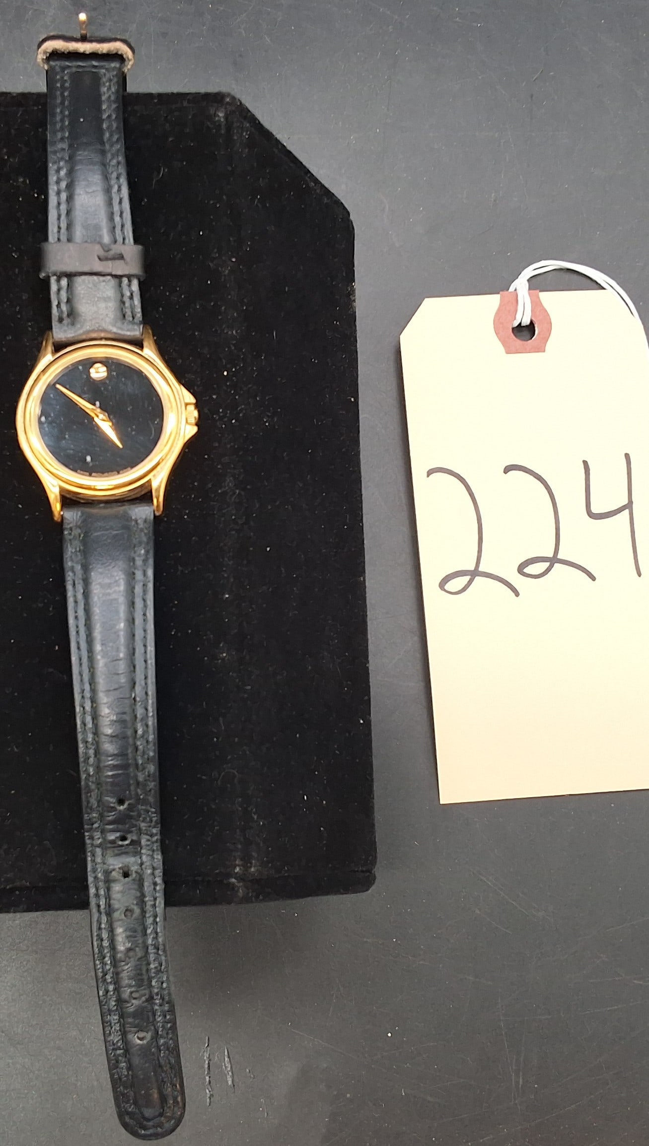 Movado black and gold tone watch 97 E4 0823 5138496: Movado black and gold tone watch 97 E4 0823 5138496 Condition All property is sold in "as is" condition and all sales are final. Teel Auctions and its consignor make no representations or warranties,