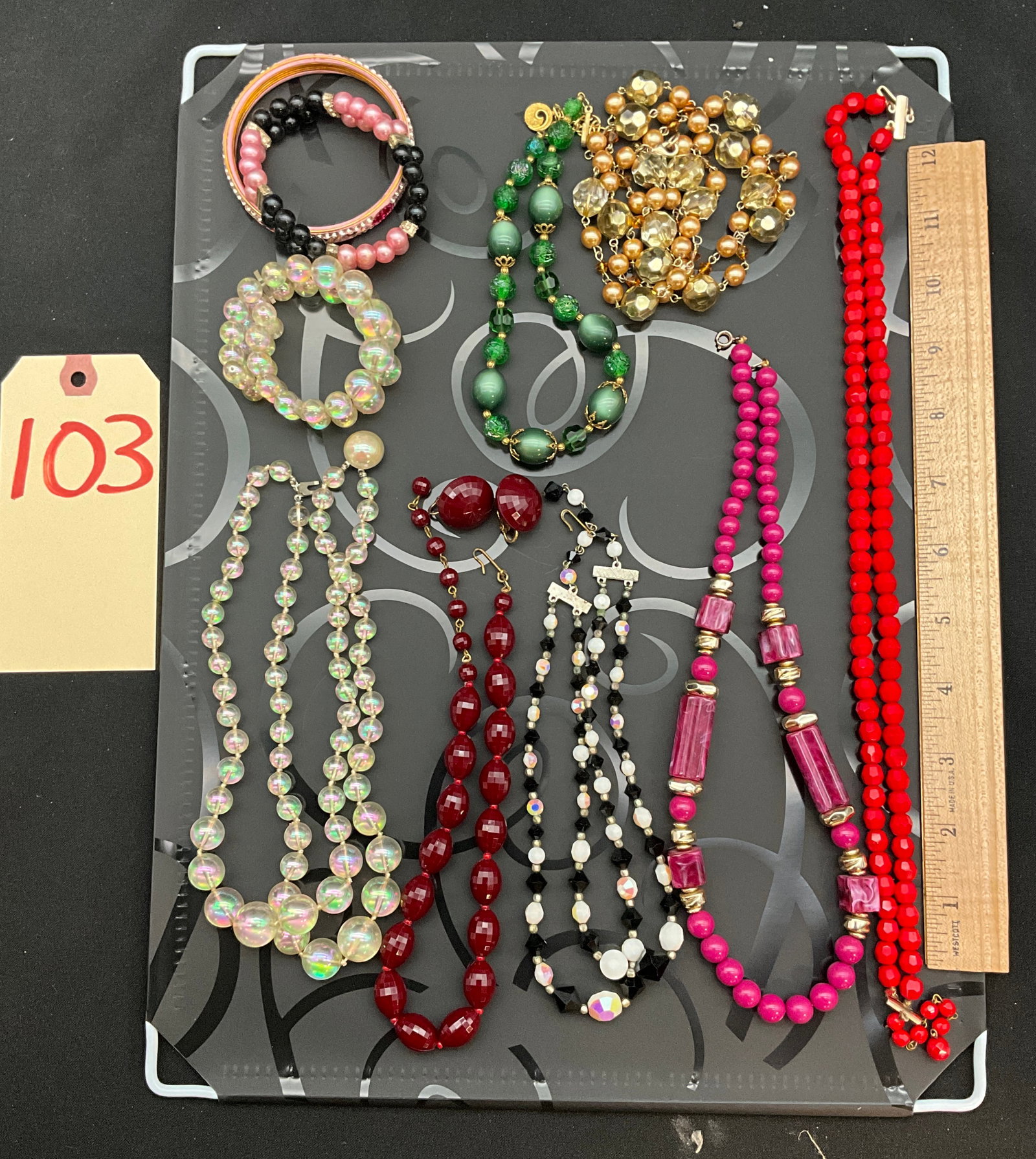 A Collection of Vintage Mid-Century Costume Jewelry Including Richelieu and Dalsheim: This assortment of mid-20th-century costume jewelry includes multiple necklaces, bracelets, and a pair of clip-on earrings. Featured items include a triple-strand iridescent aurora borealis necklace