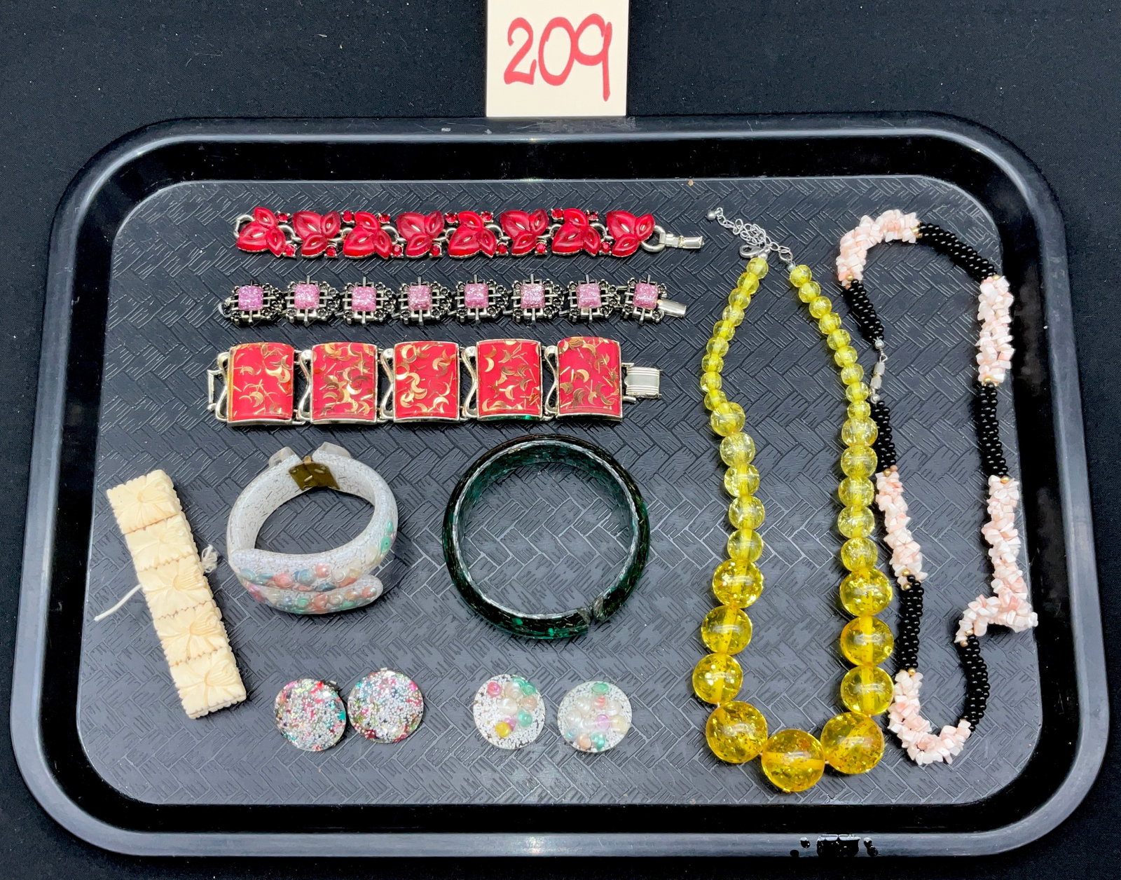 A Collection of Vintage Mid-Century Costume Jewelry: This lot features ten pieces of mid-century costume jewelry, including three signed bracelets by makers Trifari and Coro and a pair of star confetti clip-on earrings. Included are two Trifari