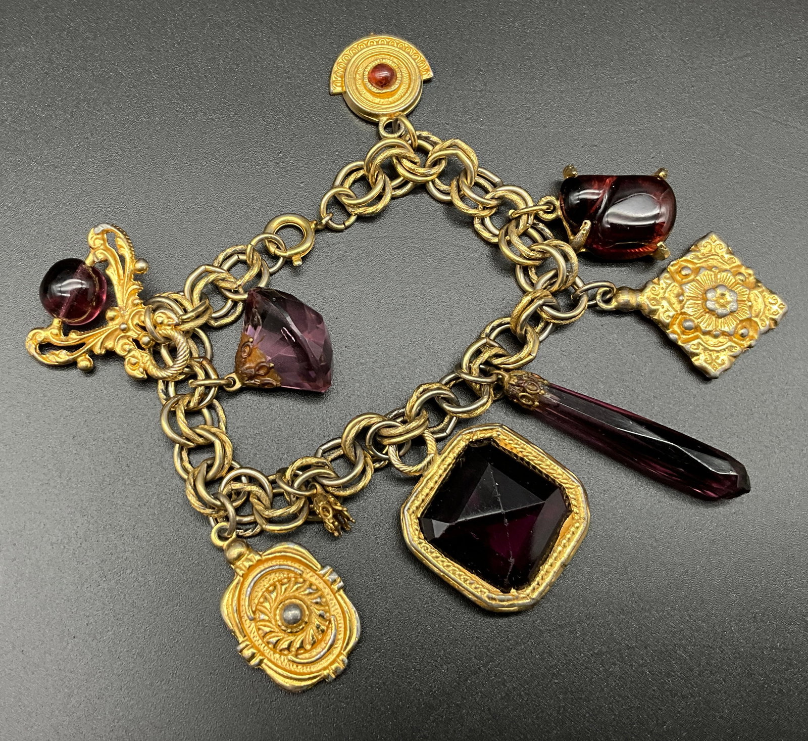 A Collection of Four Vintage Gold-Tone Costume Jewelry Charm and Button Bracelets - 4