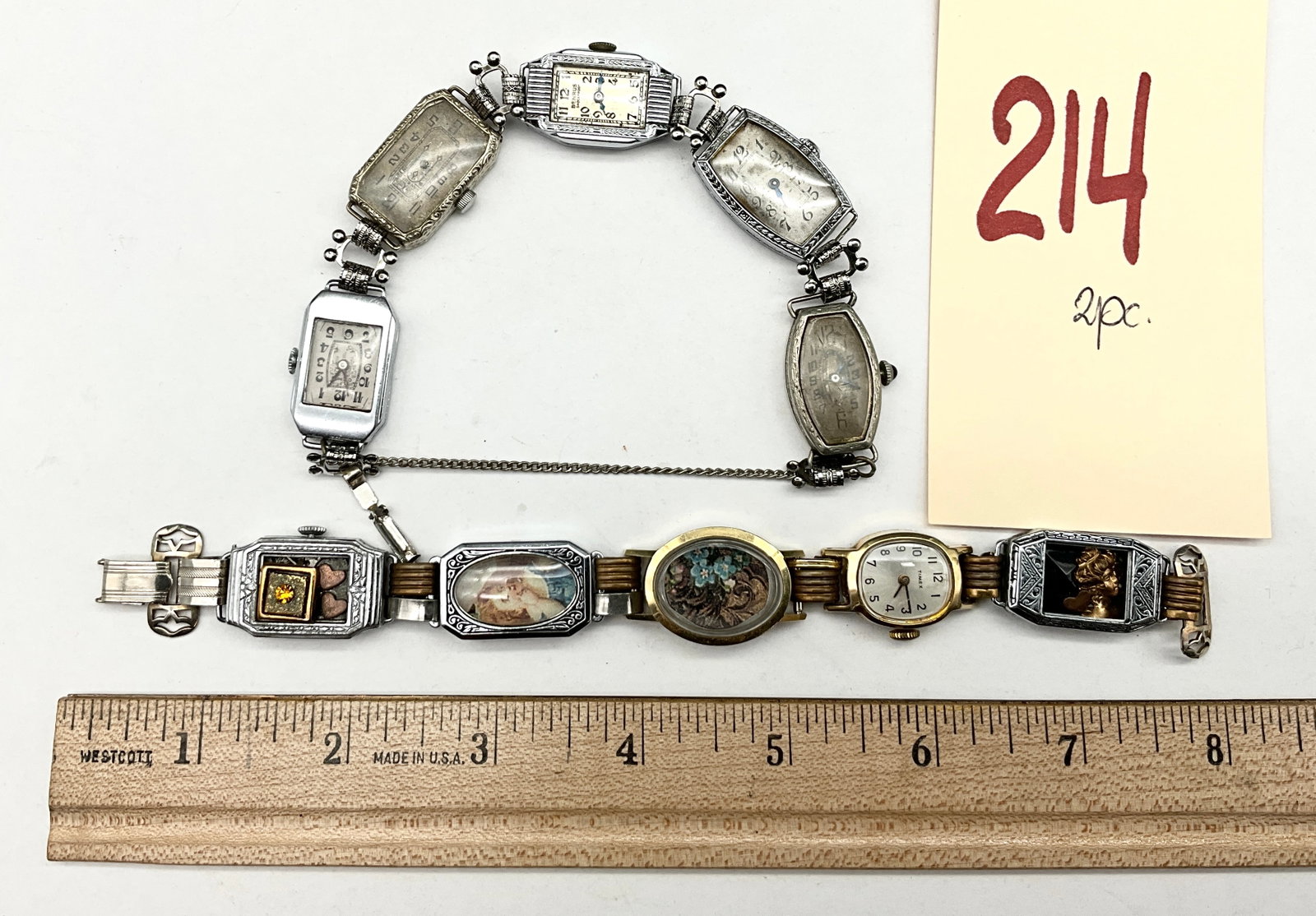 Two Vintage Repurposed Watch Head Link Bracelets: Two vintage bracelets created from repurposed watch heads and decorative elements. The first piece links five silver-tone watch heads, including makers Benrus and Van Buren, with one case professional