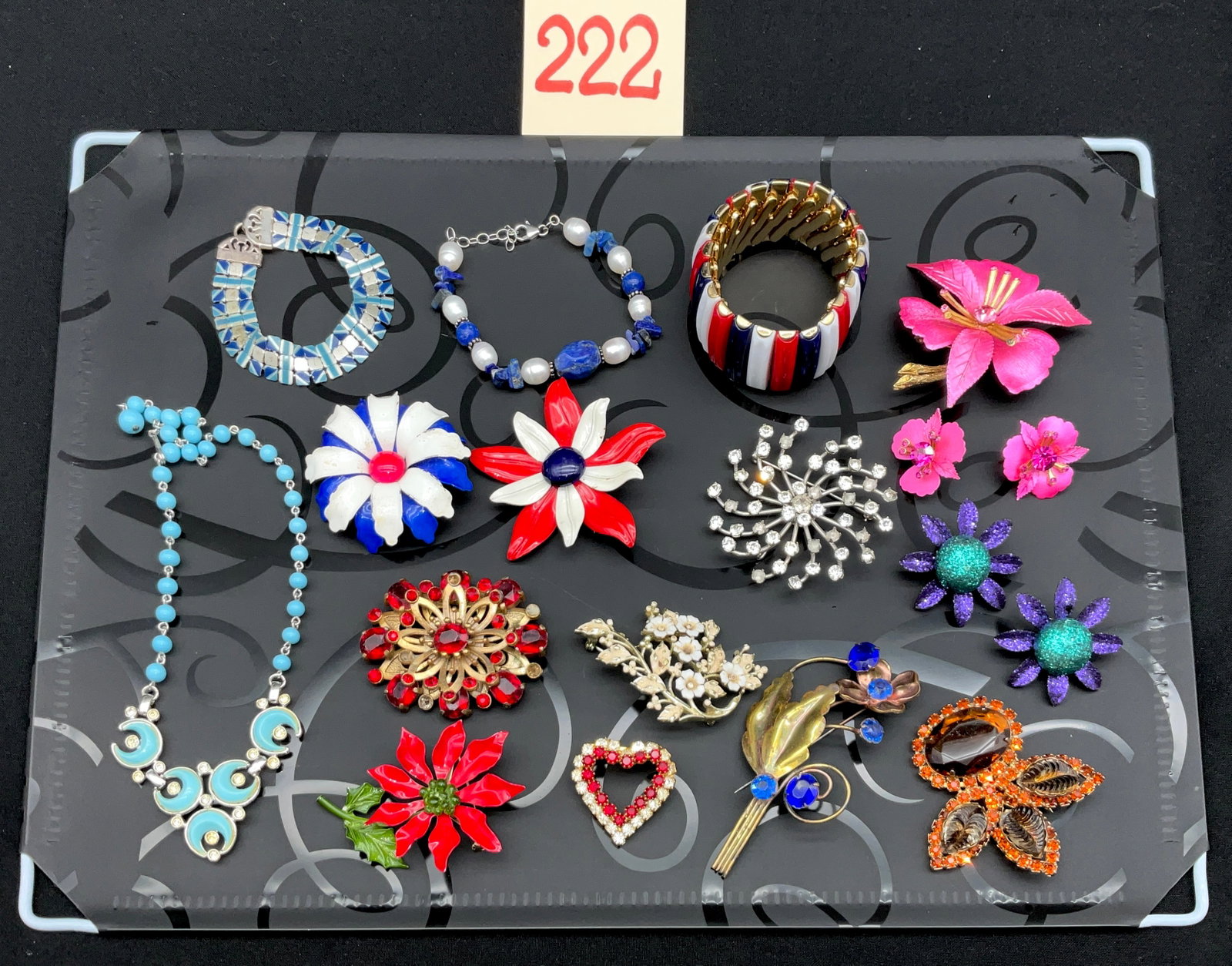 16-Piece Collection of Vintage Costume Jewelry: This 16-piece collection features various mid-20th-century costume jewelry items, including signed pieces by Coro and Sarah Coventry. The lot comprises a silver-tone rhinestone necklace, three bracele