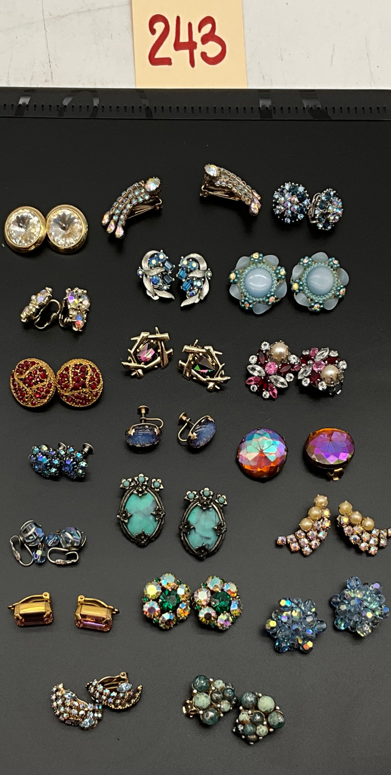 Collection of 20 Pairs of Vintage Costume Earrings: This collection contains 20 pairs of mid-century vintage costume earrings featuring floral clusters, geometric abstracts, and large round forms. The assortment includes 17 pairs of clip-on earrings an