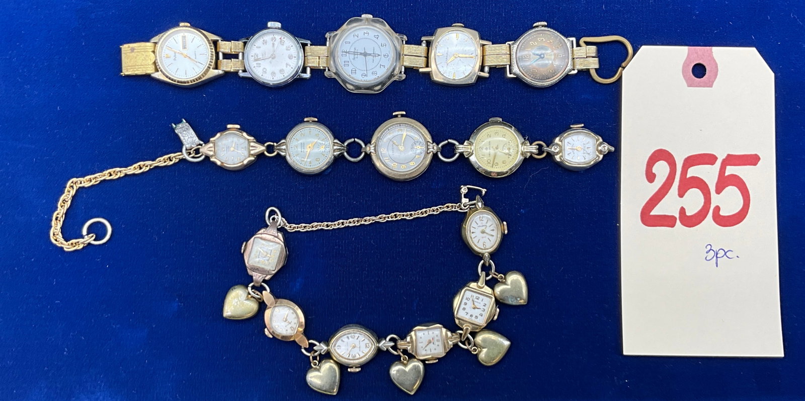 Three Vintage Watch Head and Charm Bracelets: This collection of jewelry consists of three unique bracelets assembled from various vintage and modern watch heads featuring both quartz and manual wind movements. Legible maker names include Pulsar,