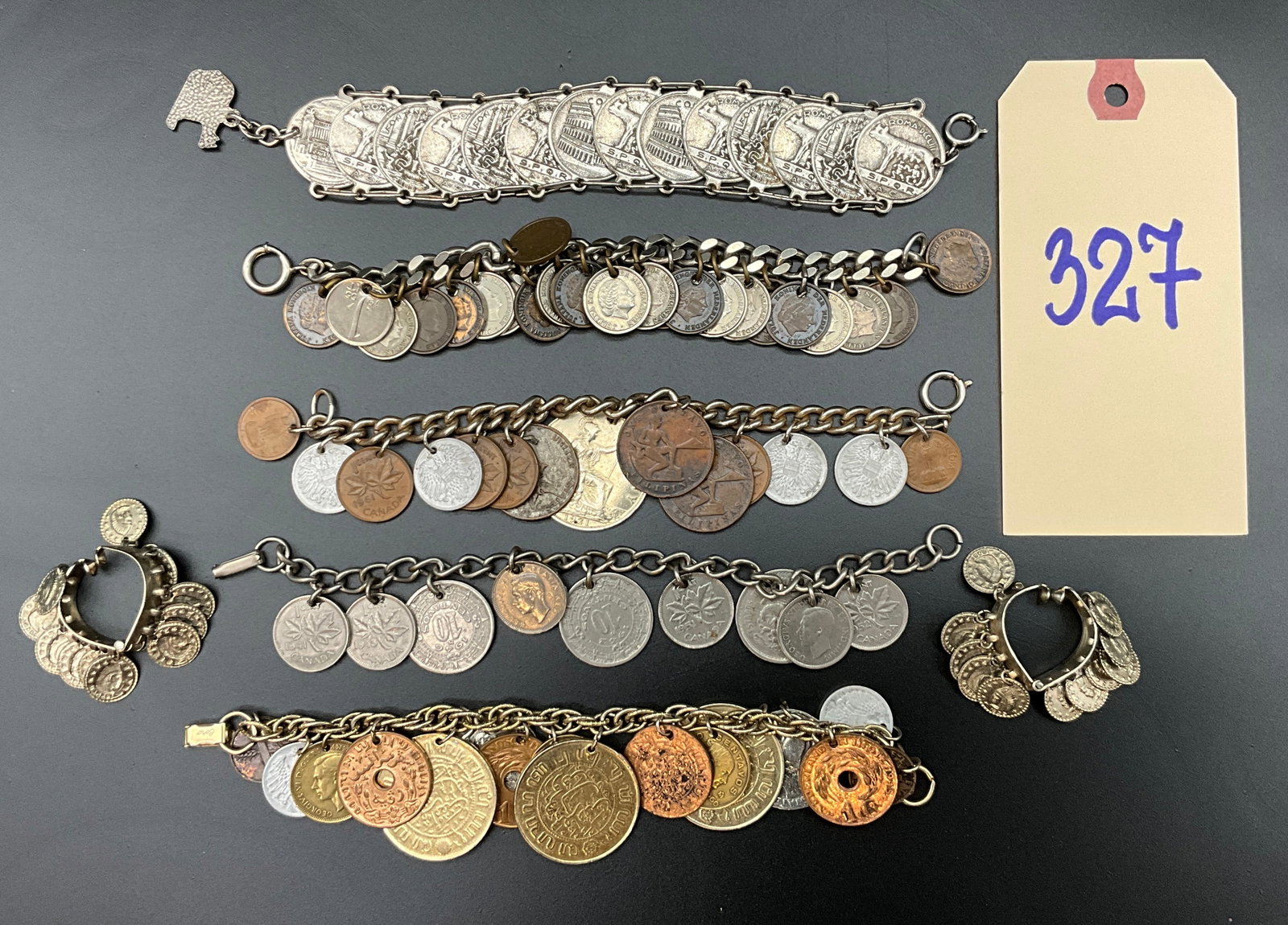 A Collection of Vintage International Coin Motif Jewelry and Coins: This collection features five coin-themed bracelets, one pair of coin-motif hoop earrings, and a loose United States quarter. The bracelets utilize various chain styles including curb and twisted