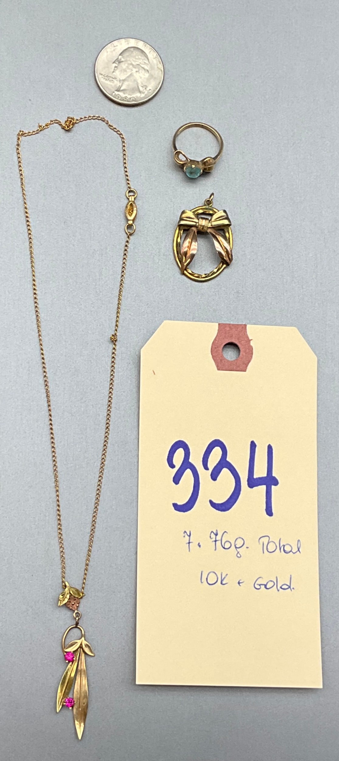 Vintage Art Nouveau Style 10K Gold Jewelry Trio: This vintage Art Nouveau style 10 karat gold jewelry collection features a necklace, ring, and oval pendant. The necklace pendant displays a foliate design set with two faceted pink gemstones and is