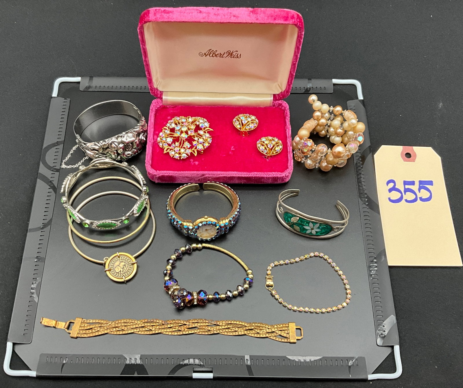 A Collection of Vintage Costume Jewelry Including Albert Weiss and Vernier: This collection of costume jewelry features a floral brooch and earring set with aurora borealis rhinestones in a velvet box marked for Albert Weiss. The assortment includes a gold-tone rhinestone-set